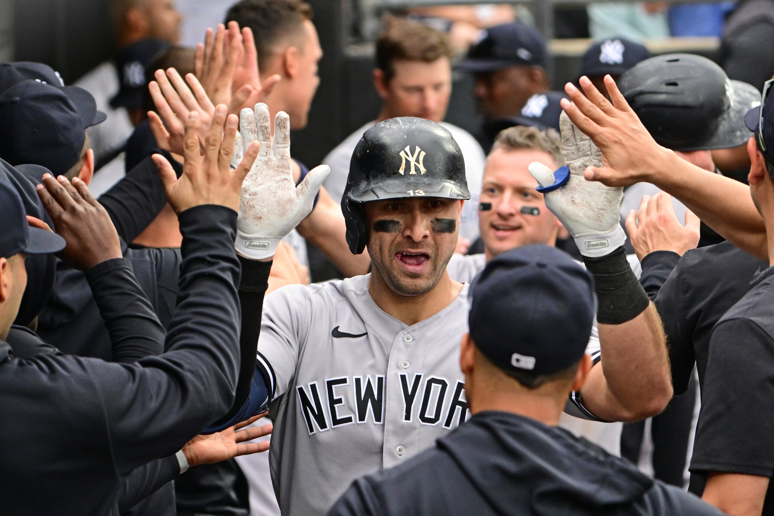 CHICAGO, ILLINOIS - MAY 15: Joey Gallo #13 of the New York Yankees celebrates in the dugout with teammates after hitting a two run home run in the ninth inning against the Chicago White Sox at Guaranteed Rate Field on May 15, 2022 in Chicago, Illinois. (Photo by Quinn Harris/Getty Images)