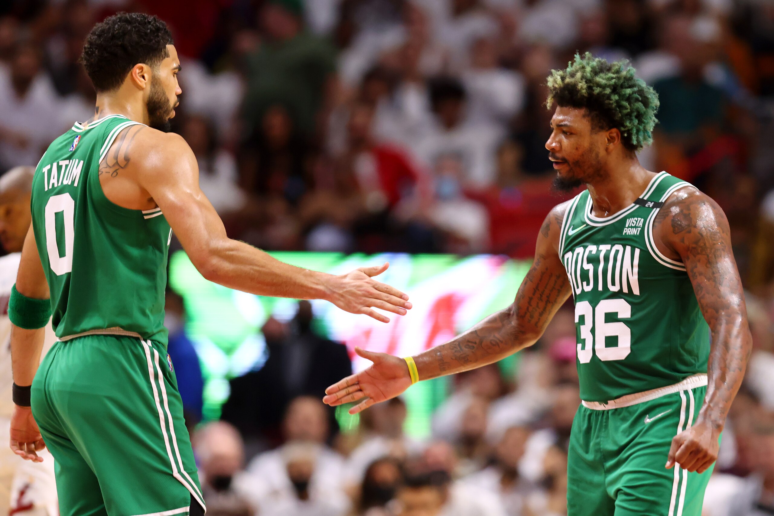 MIAMI, FLORIDA - MAY 19: Jayson Tatum #0 and Marcus Smart #36 of the Boston Celtics high five during the second quarter against the Miami Heat in Game Two of the 2022 NBA Playoffs Eastern Conference Finals at FTX Arena on May 19, 2022 in Miami, Florida. NOTE TO USER: User expressly acknowledges and agrees that, by downloading and or using this photograph, User is consenting to the terms and conditions of the Getty Images License Agreement. (Photo by Michael Reaves/Getty Images)