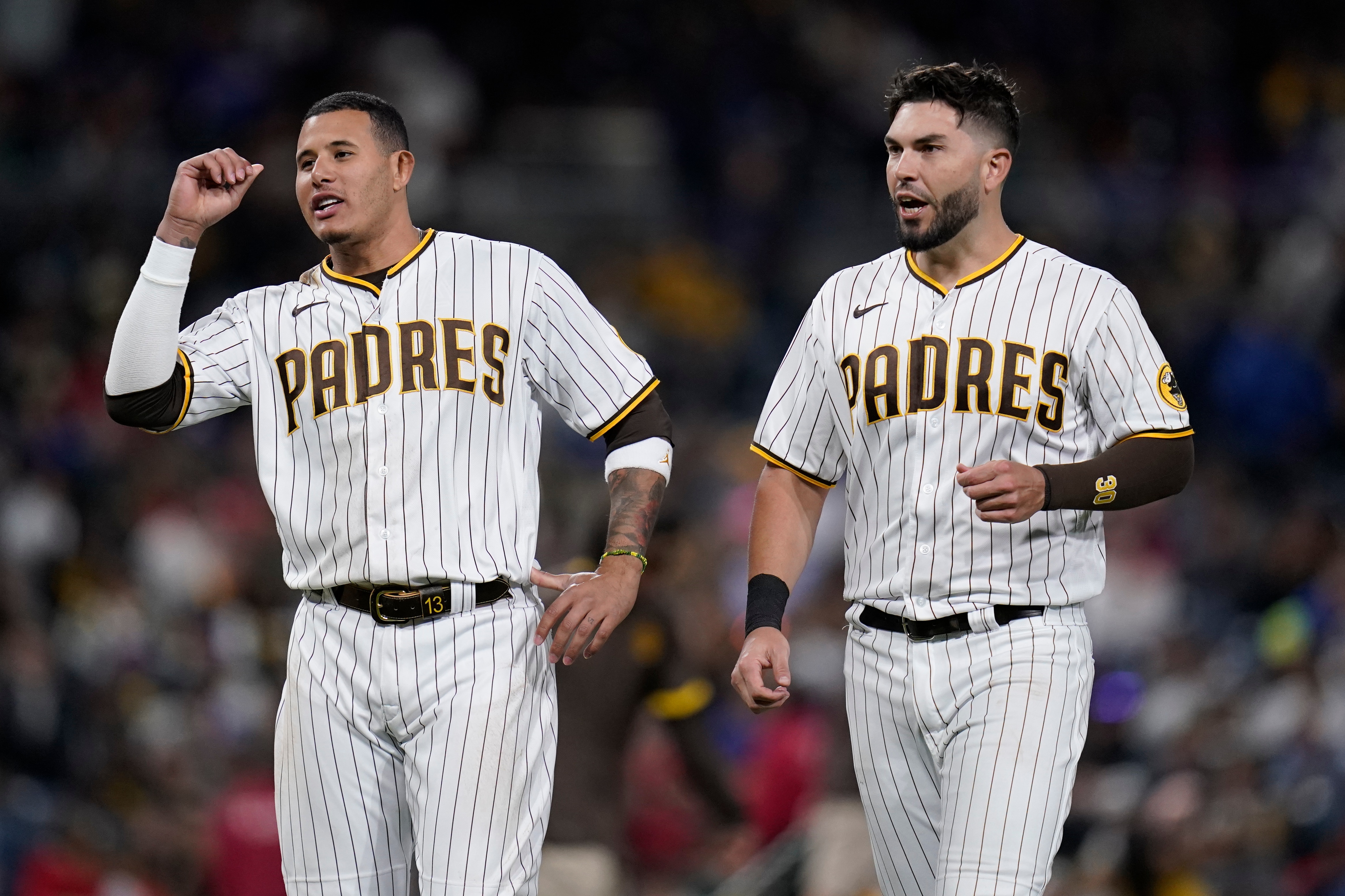San Diego Padres third baseman Manny Machado, left, talks with teammate first baseman Eric Hosmer during the sixth inning of a baseball game against the Chicago Cubs, Tuesday, May 10, 2022, in San Diego. (AP Photo/Gregory Bull)