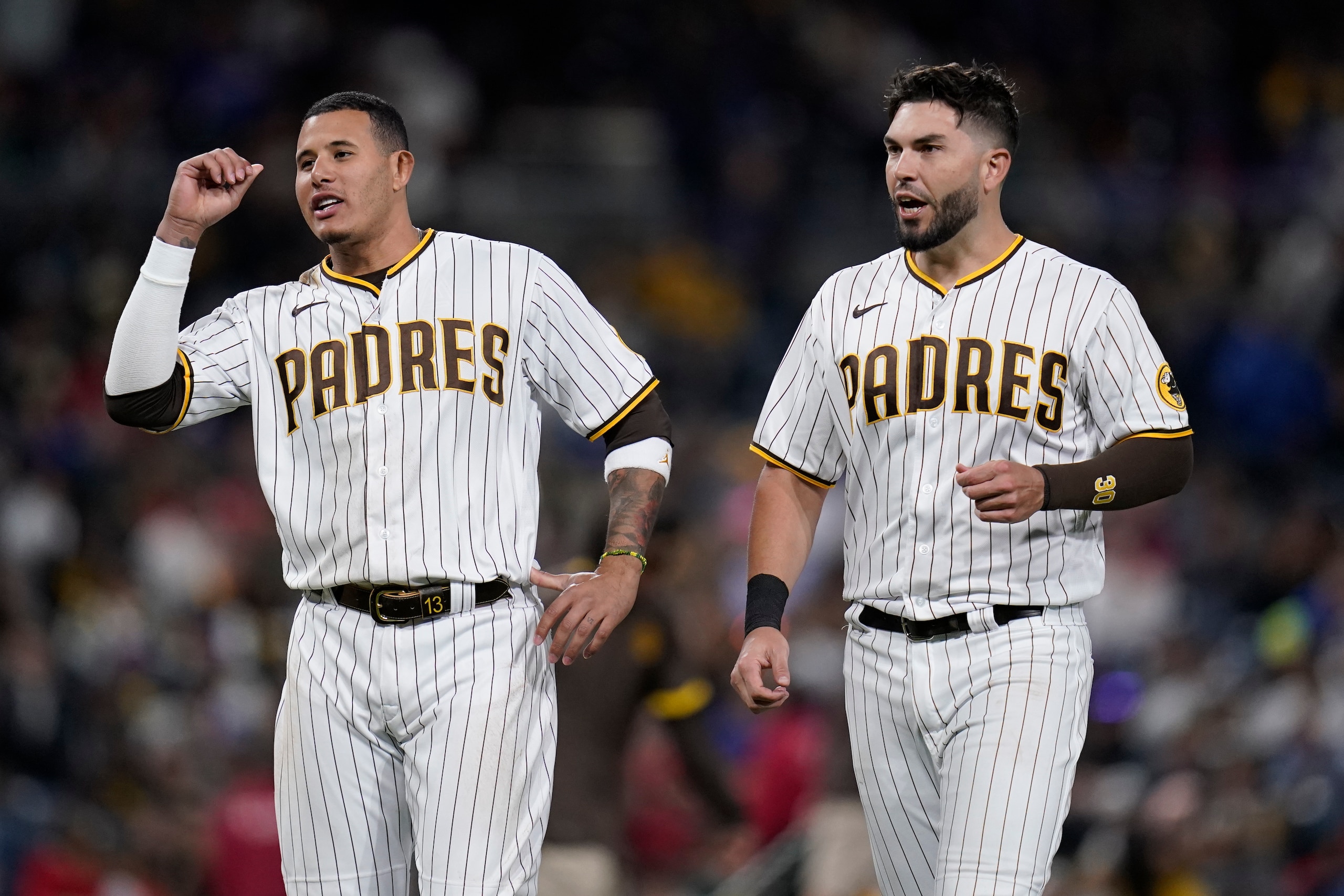 San Diego Padres third baseman Manny Machado, left, talks with teammate first baseman Eric Hosmer during the sixth inning of a baseball game against the Chicago Cubs, Tuesday, May 10, 2022, in San Diego. (AP Photo/Gregory Bull)