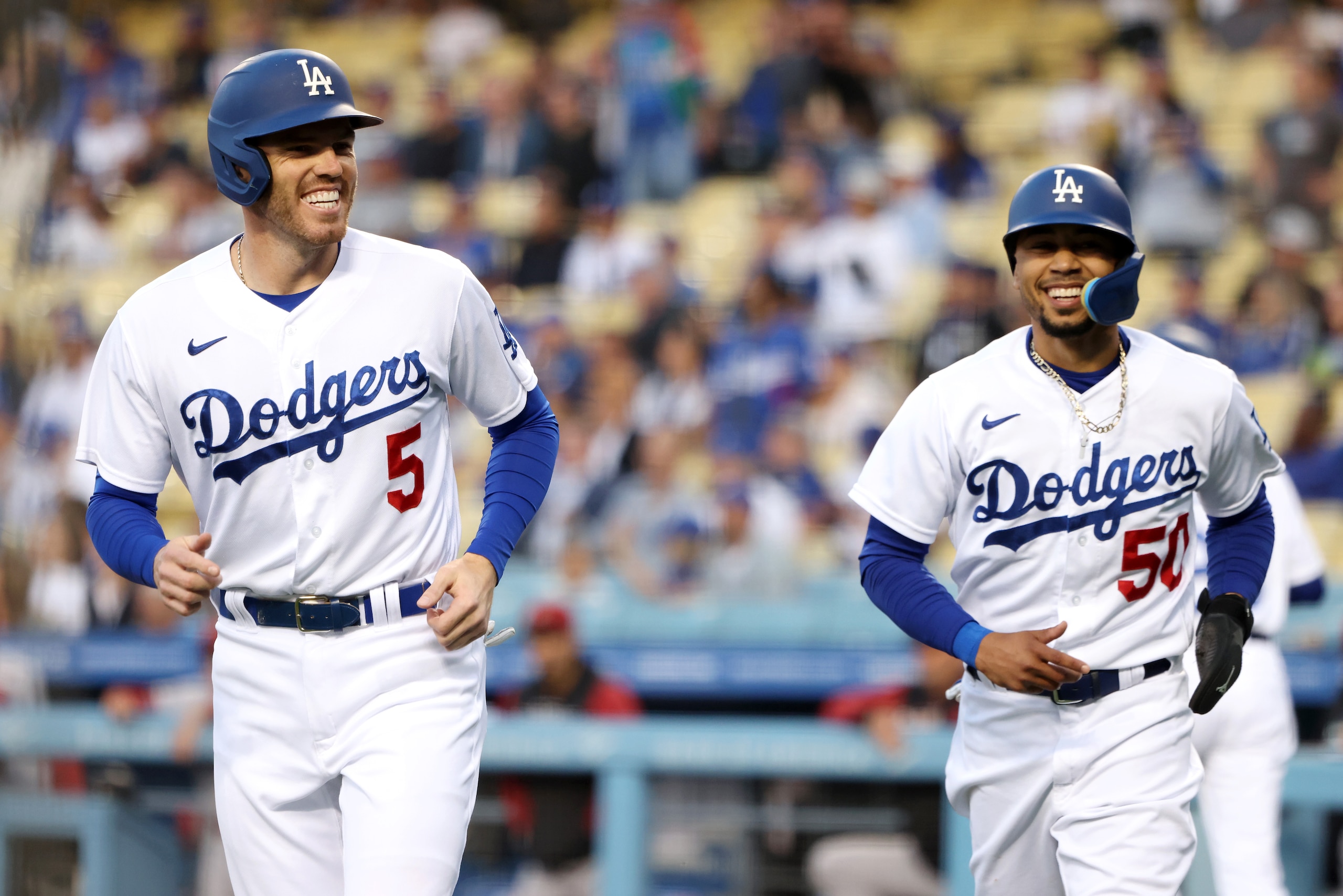 LOS ANGELES, CALIFORNIA - MAY 17: Freddie Freeman #5 and Mookie Betts #50 of the Los Angeles Dodgers react after scoring on a two-run single off the bat of Trea Turner during the first inning in game two of a doubleheader against the Arizona Diamondbacks at Dodger Stadium on May 17, 2022 in Los Angeles, California. (Photo by Katelyn Mulcahy/Getty Images)