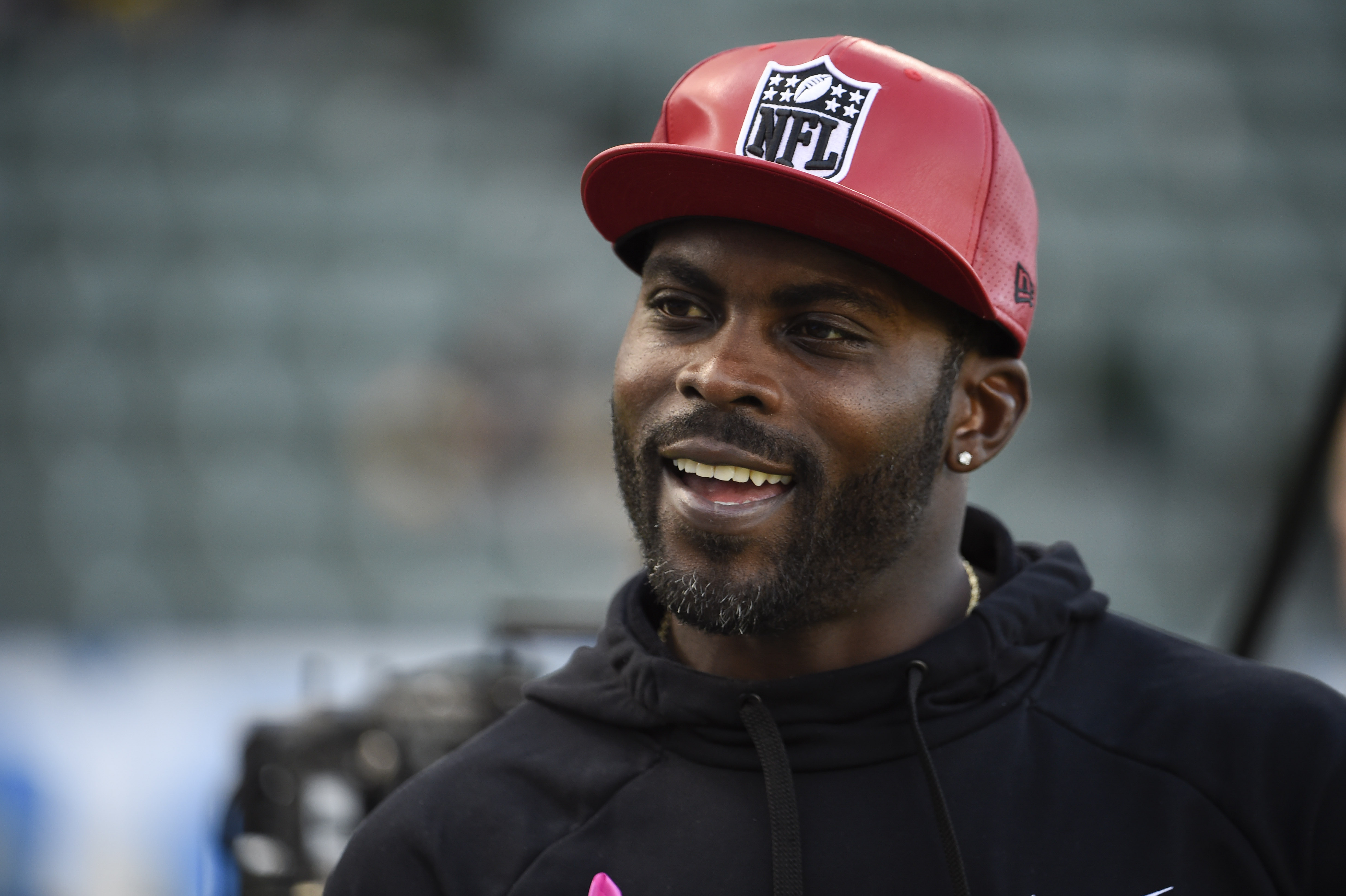 CARSON, CA - OCTOBER 13: Former NFL quarterback Michael Vick stands on the field before a game between the Pittsburgh Steelers and the Los Angeles Chargers at Dignity Health Sports Park October 13, 2019 in Carson, California.  (Photo by Denis Poroy/Getty Images)