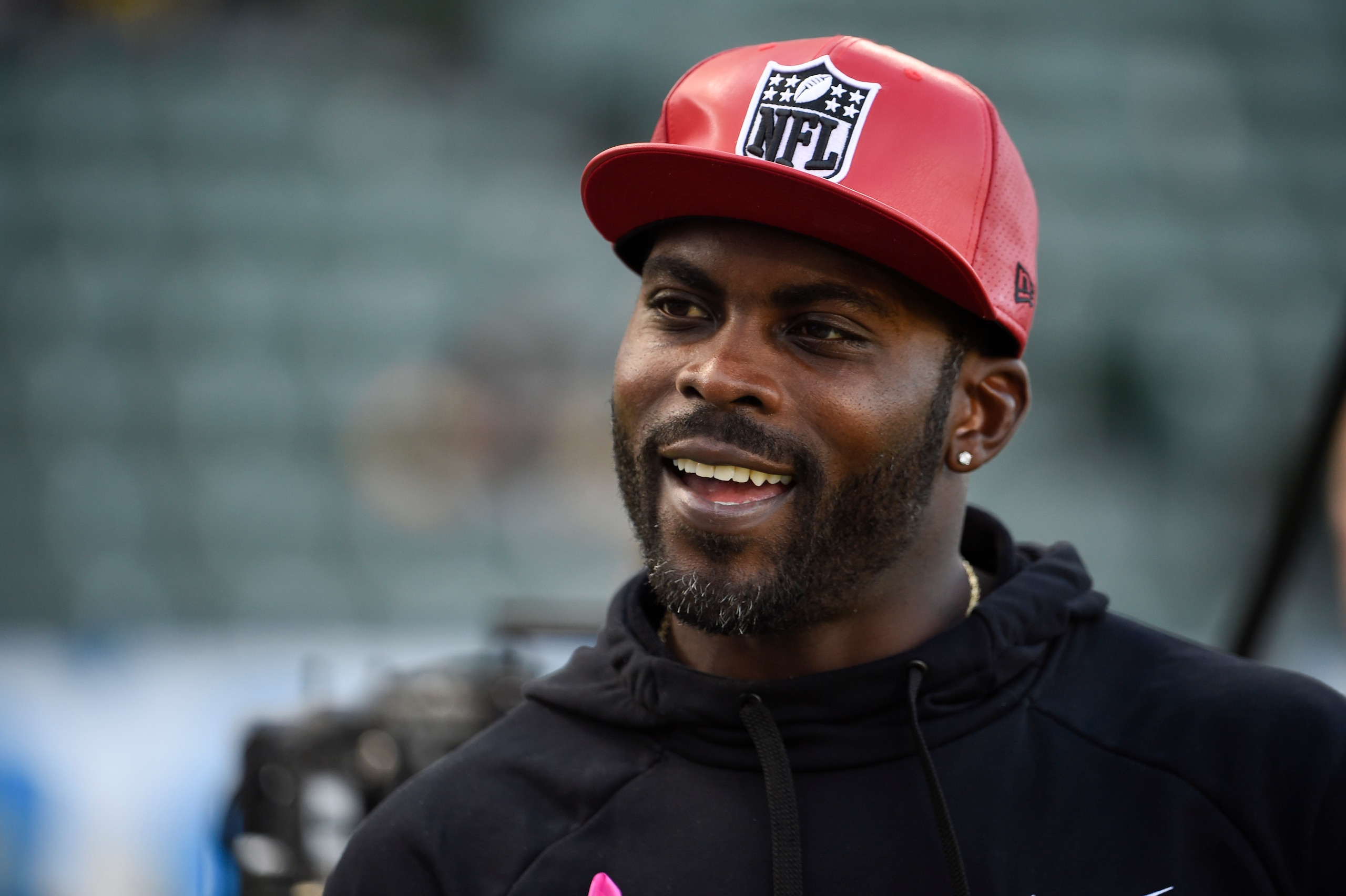 CARSON, CA - OCTOBER 13: Former NFL quarterback Michael Vick stands on the field before a game between the Pittsburgh Steelers and the Los Angeles Chargers at Dignity Health Sports Park October 13, 2019 in Carson, California.  (Photo by Denis Poroy/Getty Images)