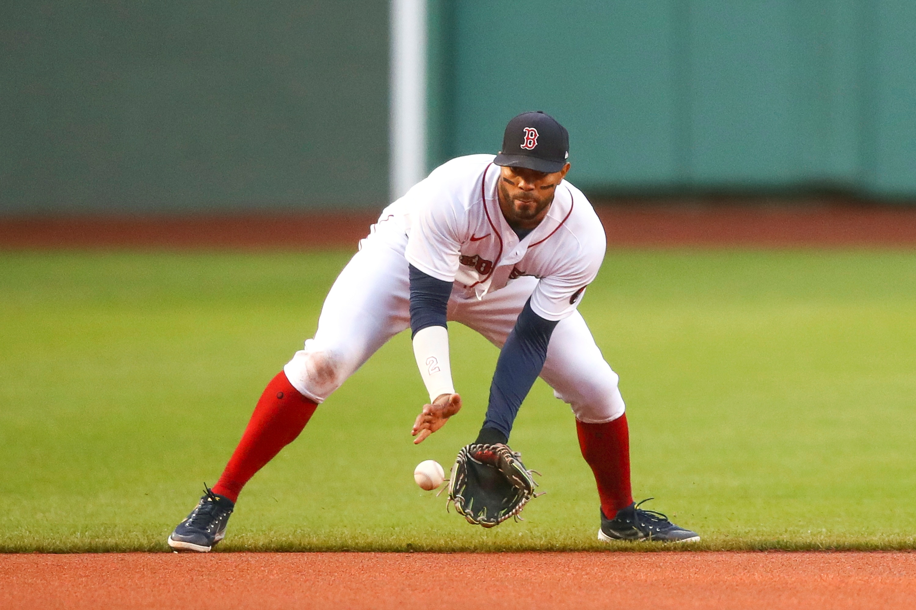BOSTON, MA - MAY 19:  Xander Bogaerts #2 of the Boston Red Sox fields a ground ball during a game against the Seattle Mariners at Fenway Park on May 19, 2022 in Boston, Massachusetts.  (Photo by Adam Glanzman/Getty Images)