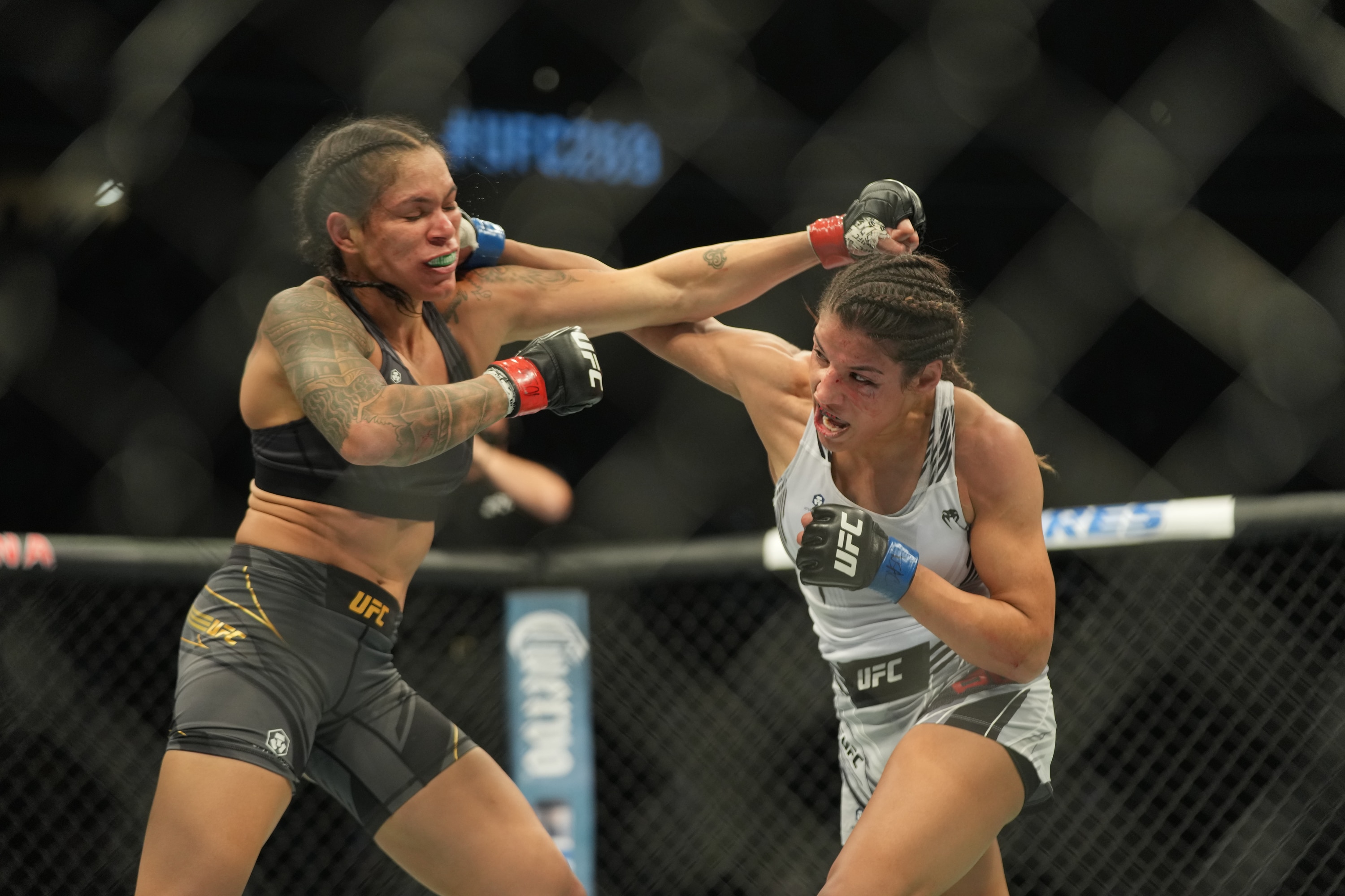 LAS VEGAS, NV - DECEMBER 11: (R-L) Julianna Peña punches Amanda Nunes in their womans bantamweight title fight during the UFC 269 on December 11, 2021, at T-Mobile Arena in Las Vegas, NV. (Photo by Louis Grasse/PxImages/Icon Sportswire via Getty Images)