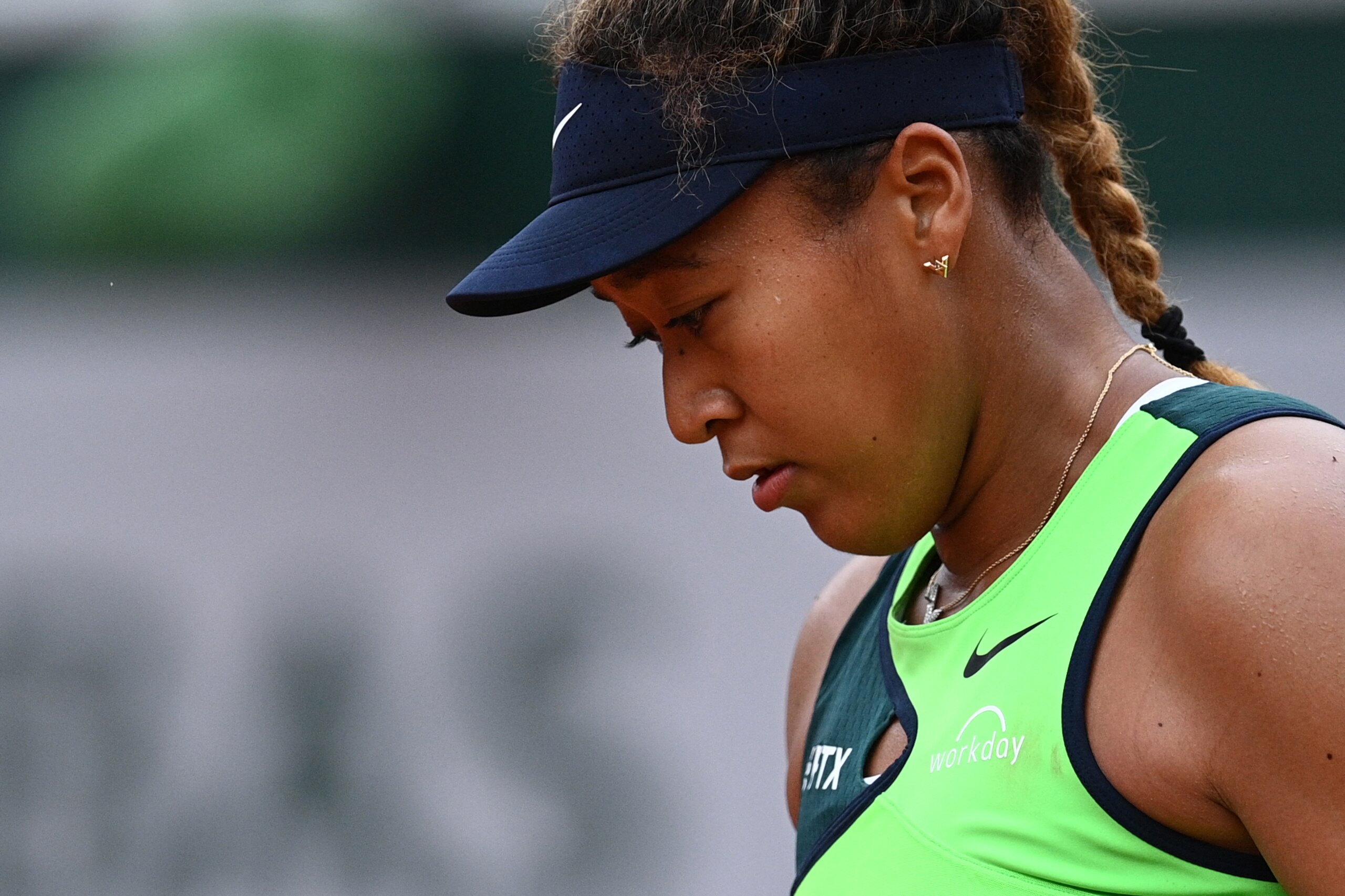 Japan's Naomi Osaka reacts as she plays against US' Amanda Anisimova during their women's singles match on day two of the Roland-Garros Open tennis tournament at the Court Suzanne-Lenglen in Paris on May 23, 2022. (Photo by Christophe ARCHAMBAULT / AFP) (Photo by CHRISTOPHE ARCHAMBAULT/AFP via Getty Images)