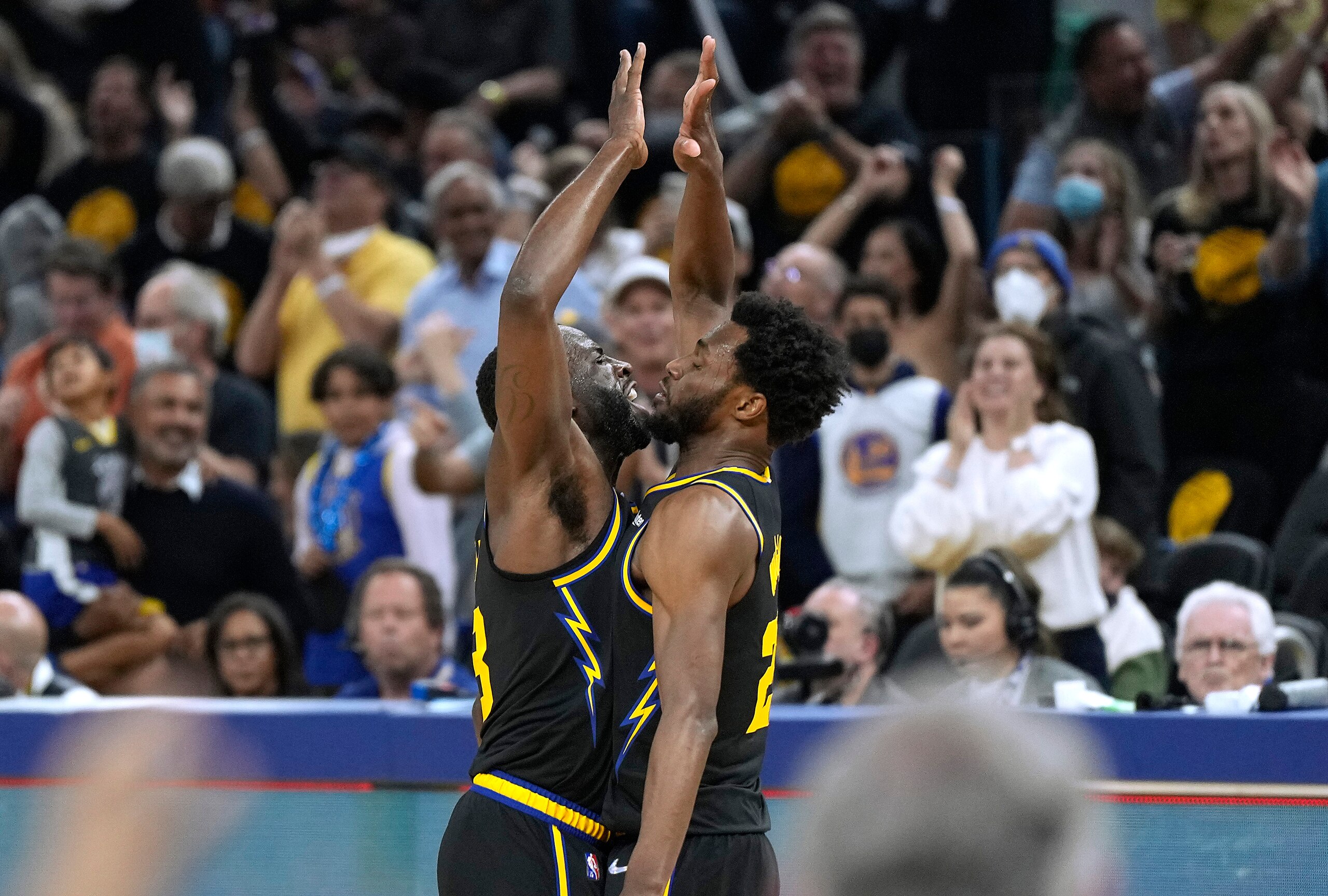 SAN FRANCISCO, CALIFORNIA - MAY 07: Draymond Green #23 and Andrew Wiggins #22 of the Golden State Warriors celebrates after Wiggins scored and was fouled on the shot against the Memphis Grizzlies during the first half of Game Three of the Western Conference Semifinals of the NBA Playoffs at Chase Center on May 07, 2022 in San Francisco, California. NOTE TO USER: User expressly acknowledges and agrees that, by downloading and or using this photograph, User is consenting to the terms and conditions of the Getty Images License Agreement. (Photo by Thearon W. Henderson/Getty Images)
