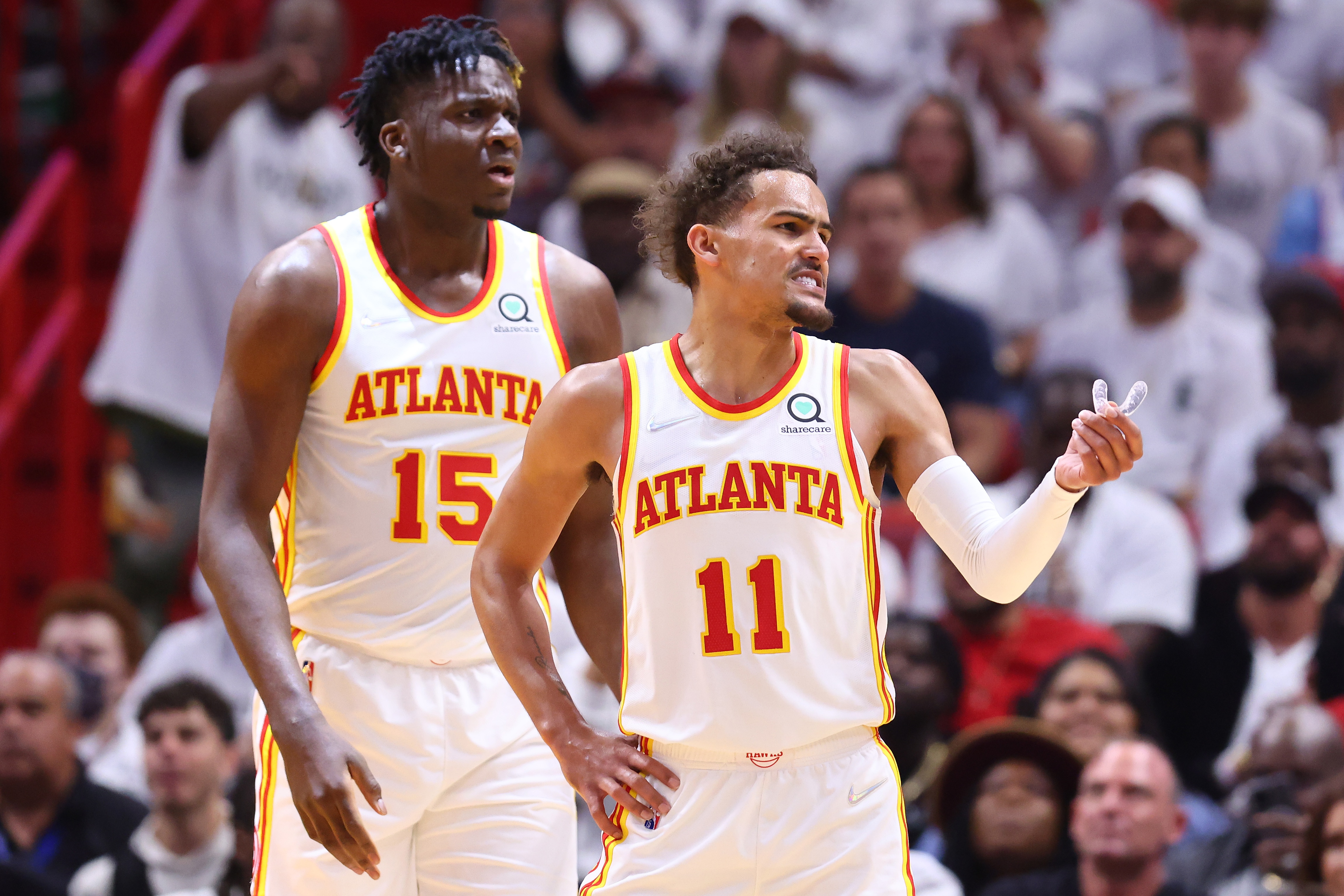 MIAMI, FLORIDA - APRIL 26: Clint Capela #15 and Trae Young #11 of the Atlanta Hawks react against the Miami Heat during the first half in Game Five of the Eastern Conference First Round at FTX Arena on April 26, 2022 in Miami, Florida. NOTE TO USER: User expressly acknowledges and agrees that, by downloading and or using this photograph, User is consenting to the terms and conditions of the Getty Images License Agreement.  (Photo by Michael Reaves/Getty Images)