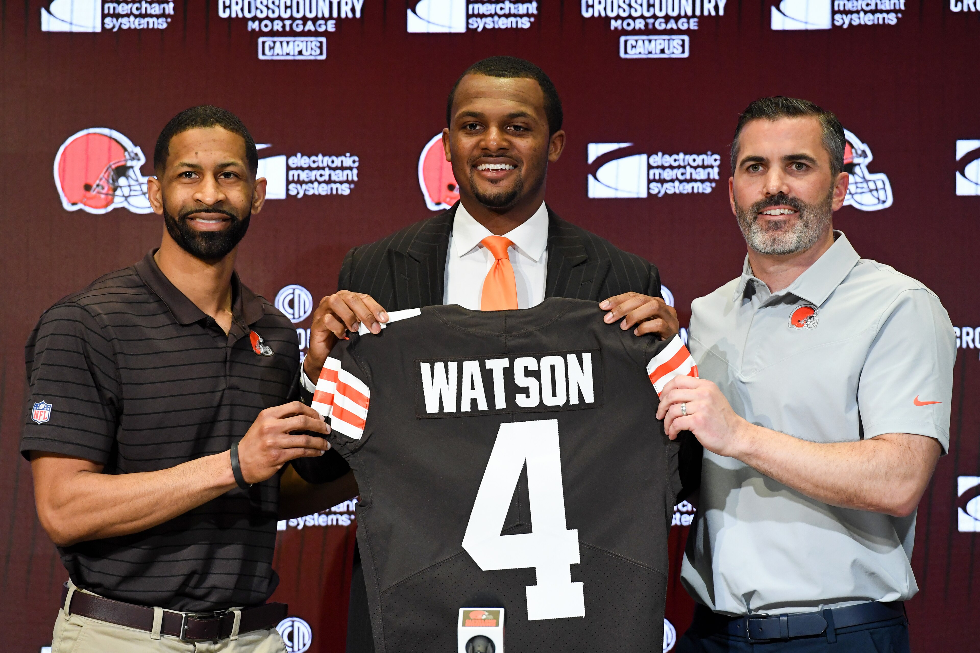 BEREA, OHIO - MARCH 25: Quarterback Deshaun Watson #4 of the Cleveland Browns is introduced by general manager Andrew Berry (L) and head coach Kevin Stefanski during a press conference at CrossCountry Mortgage Campus on March 25, 2022 in Berea, Ohio. (Photo by Nick Cammett/Getty Images)