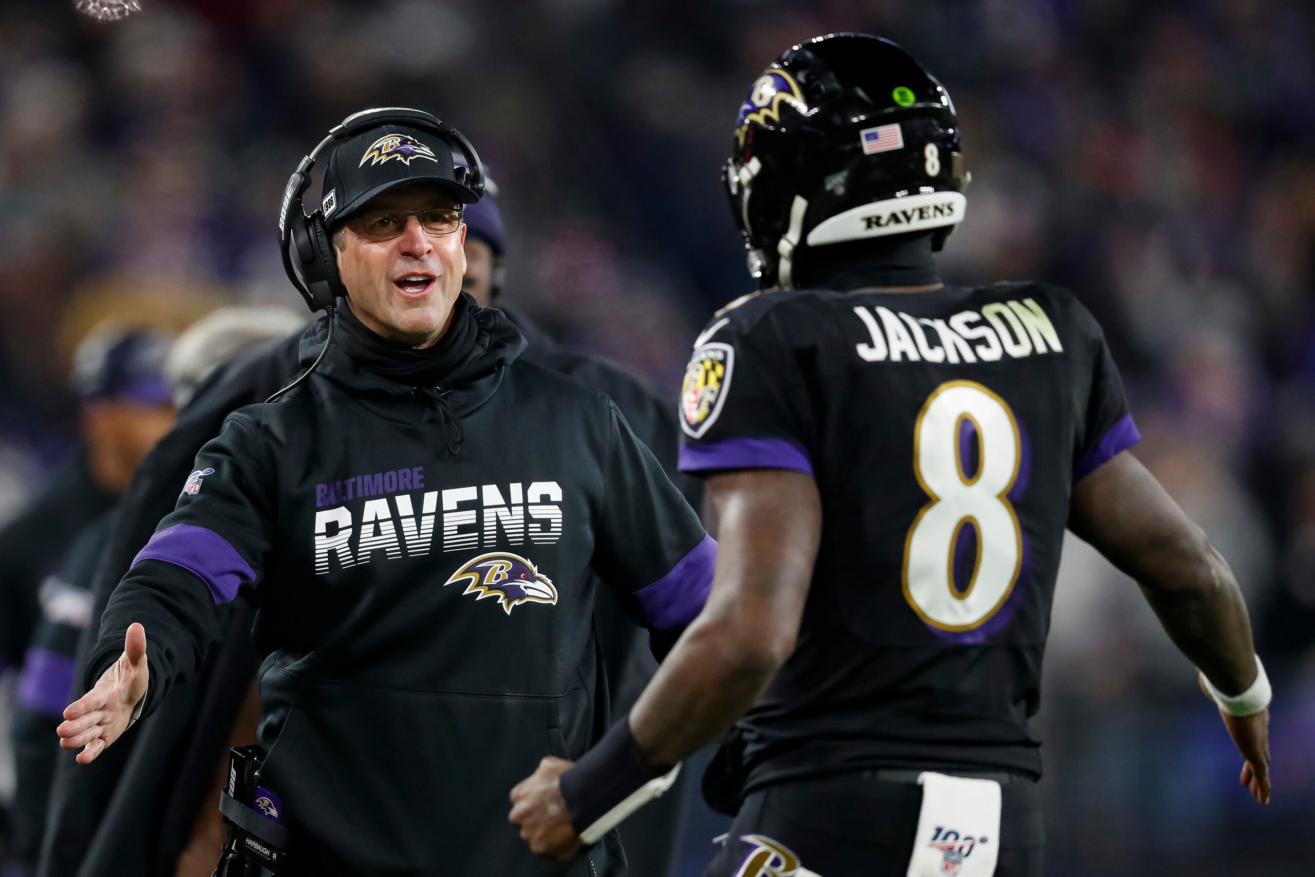 BALTIMORE, MD - DECEMBER 12: Head coach John Harbaugh of the Baltimore Ravens celebrates with Lamar Jackson #8 after a scoring play against the New York Jets during the second half at M&T Bank Stadium on December 12, 2019 in Baltimore, Maryland. (Photo by Scott Taetsch/Getty Images)