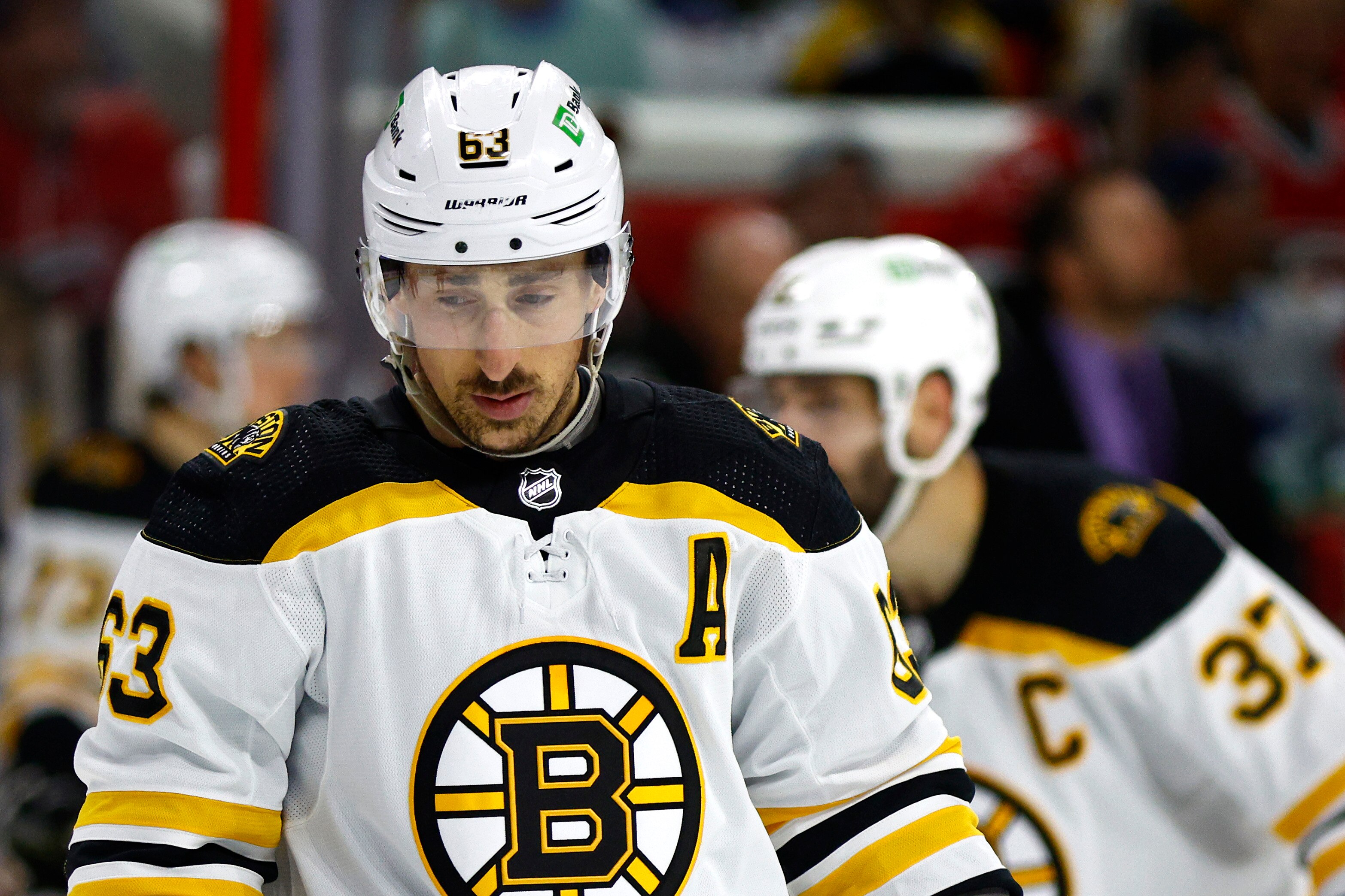 RALEIGH, NORTH CAROLINA - MAY 14: Brad Marchand #63 of the Boston Bruins looks on during the second period in Game Seven of the First Round of the 2022 Stanley Cup Playoffs against the Carolina Hurricanes at PNC Arena on May 14, 2022 in Raleigh, North Carolina. (Photo by Jared C. Tilton/Getty Images)