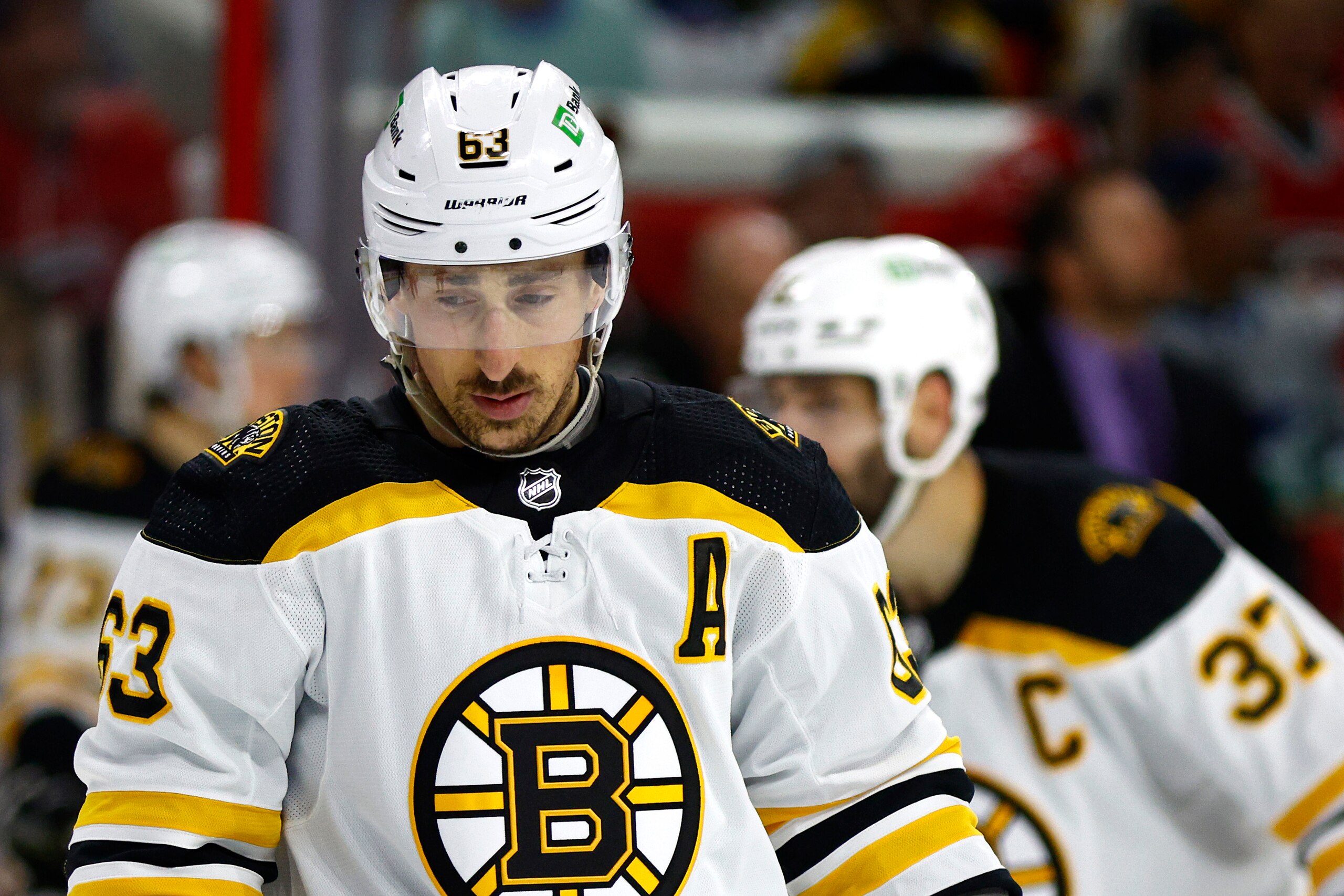 RALEIGH, NORTH CAROLINA - MAY 14: Brad Marchand #63 of the Boston Bruins looks on during the second period in Game Seven of the First Round of the 2022 Stanley Cup Playoffs against the Carolina Hurricanes at PNC Arena on May 14, 2022 in Raleigh, North Carolina. (Photo by Jared C. Tilton/Getty Images)