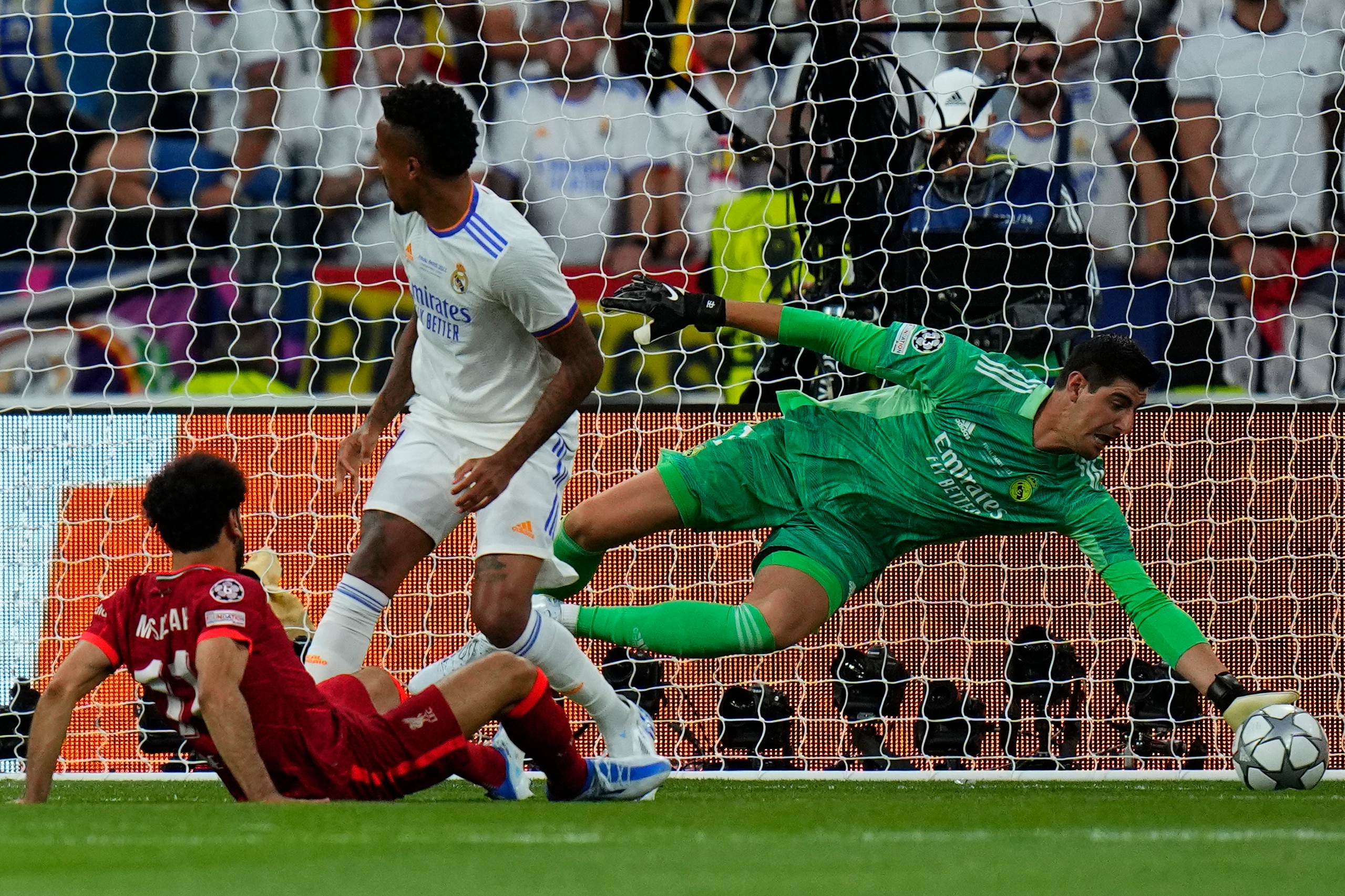 Real Madrid's goalkeeper Thibaut Courtois saves Liverpool's Mohamed Salah's shot during the Champions League final soccer match between Liverpool and Real Madrid at the Stade de France in Saint Denis near Paris, Saturday, May 28, 2022. (AP Photo/Petr David Josek)