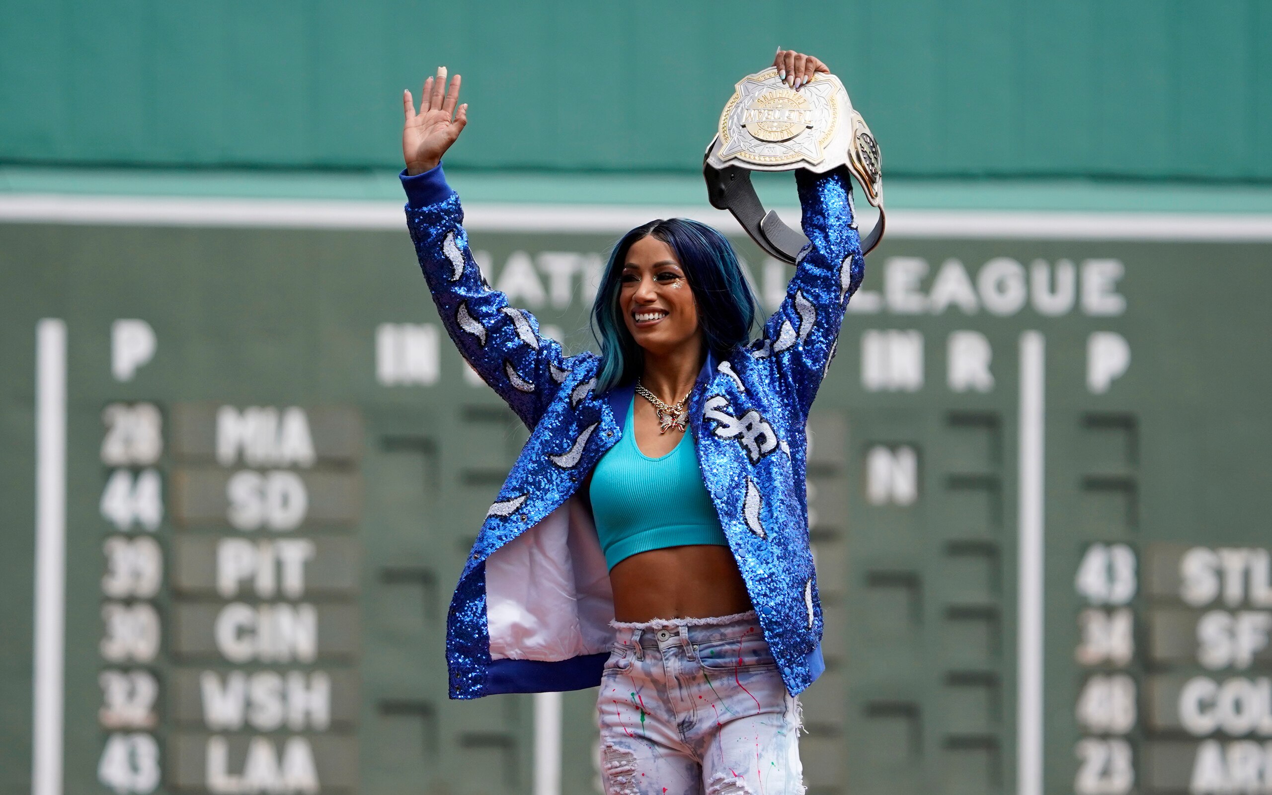 WWE wrestler Sasha Banks reacts before throwing out the first pitch before the start of baseball game between the Boston Red Sox and the Chicago White Sox at Fenway Park, Sunday, May 8, 2022, in Boston. (AP Photo/Mary Schwalm) WWE wrestler Sasha Banks reacts before throwing out the first pitch before the start of baseball game between the Boston Red Sox and the Chicago White Sox at Fenway Park, Sunday, May 8, 2022, in Boston. (AP Photo/Mary Schwalm)