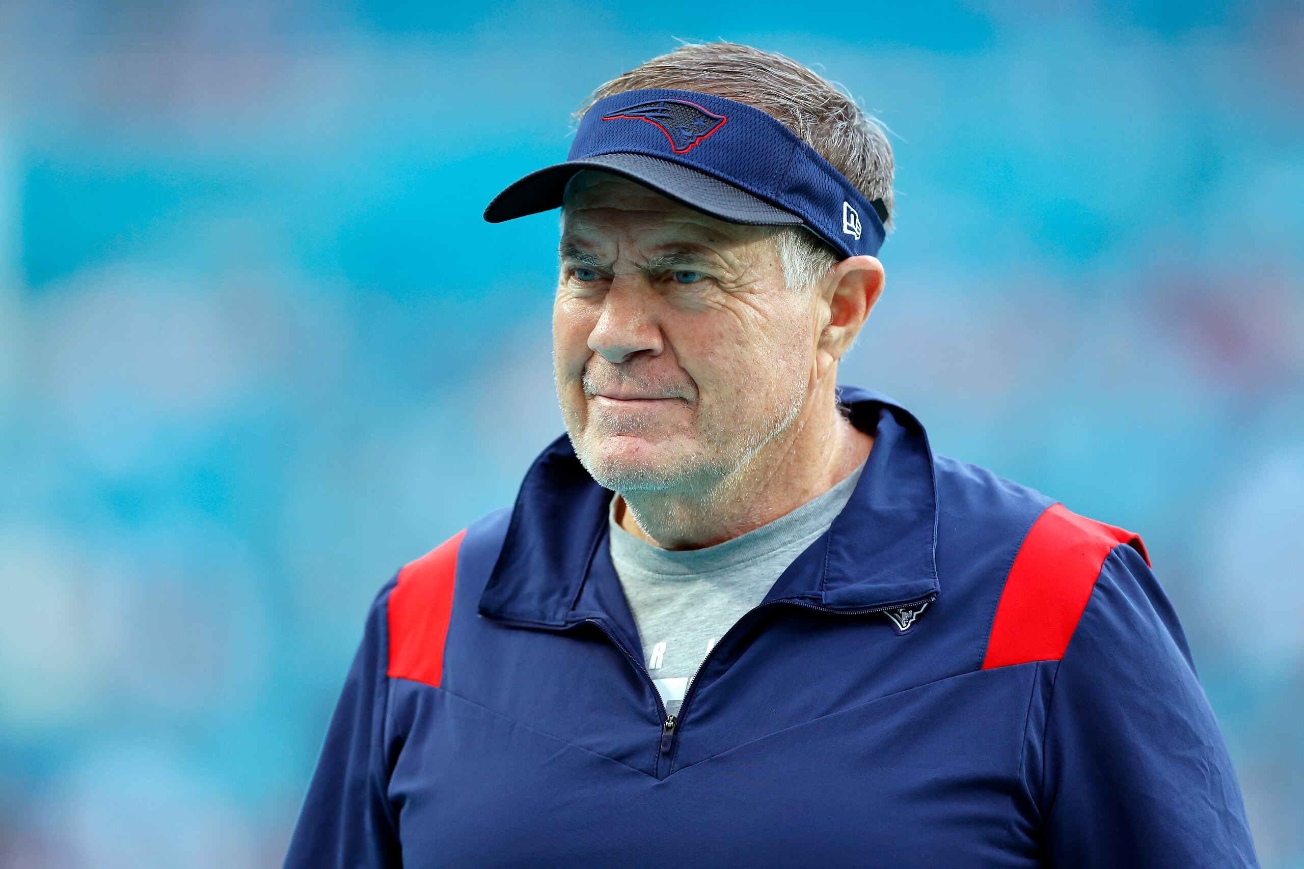 MIAMI GARDENS, FLORIDA - JANUARY 09: Head coach Bill Belichick of the New England Patriots looks on during warm ups prior to the game against the Miami Dolphins at Hard Rock Stadium on January 09, 2022 in Miami Gardens, Florida. (Photo by Michael Reaves/Getty Images) MIAMI GARDENS, FLORIDA - JANUARY 09: Head coach Bill Belichick of the New England Patriots looks on during warm ups prior to the game against the Miami Dolphins at Hard Rock Stadium on January 09, 2022 in Miami Gardens, Florida. (Photo by Michael Reaves/Getty Images)