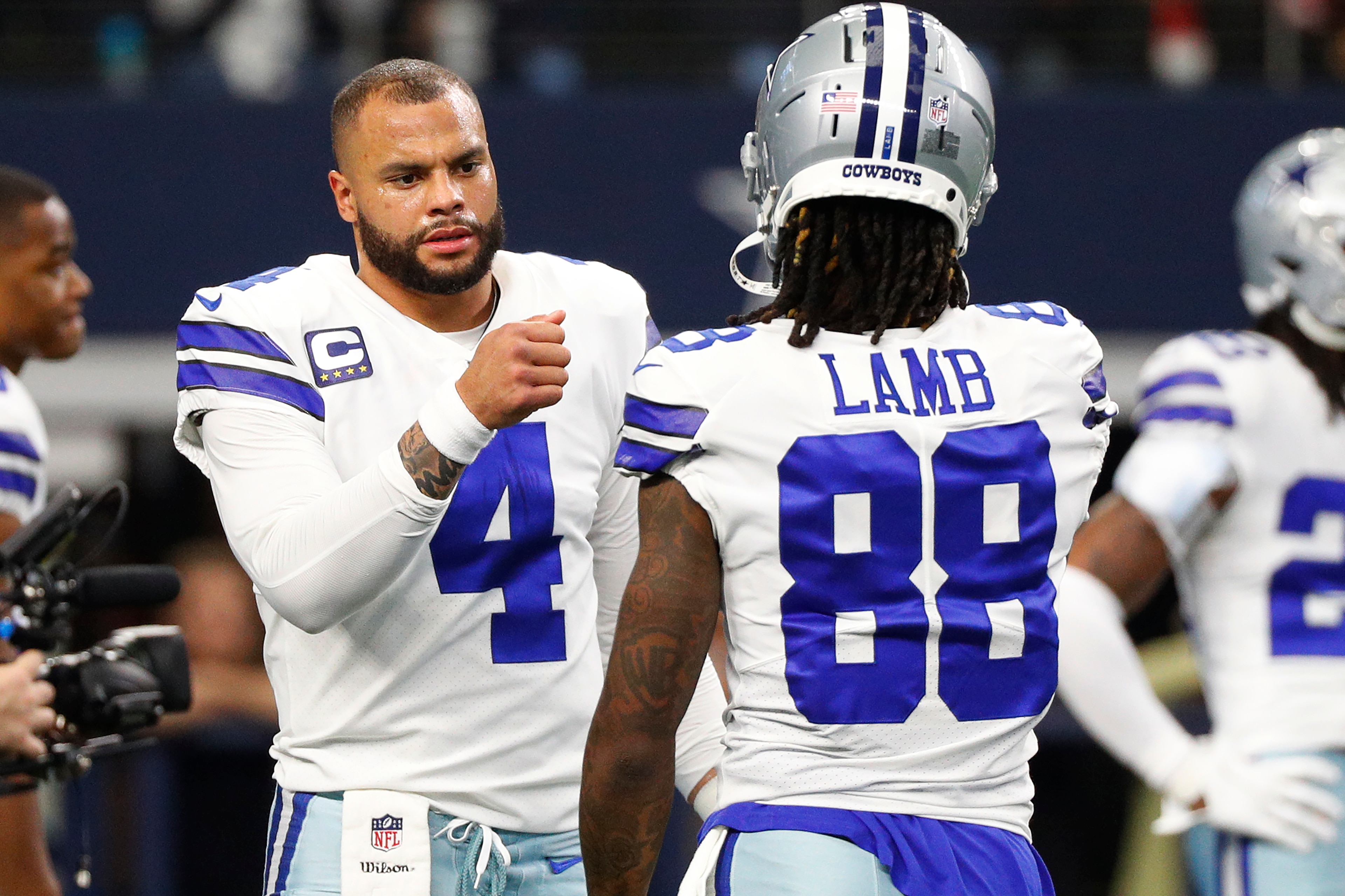 ARLINGTON, TEXAS - JANUARY 16: Dak Prescott #4 and CeeDee Lamb #88 of the Dallas Cowboys warm up prior to a game against the San Francisco 49ers in the NFC Wild Card Playoff game at AT&T Stadium on January 16, 2022 in Arlington, Texas. (Photo by Richard Rodriguez/Getty Images) ARLINGTON, TEXAS - JANUARY 16: Dak Prescott #4 and CeeDee Lamb #88 of the Dallas Cowboys warm up prior to a game against the San Francisco 49ers in the NFC Wild Card Playoff game at AT&T Stadium on January 16, 2022 in Arlington, Texas. (Photo by Richard Rodriguez/Getty Images)