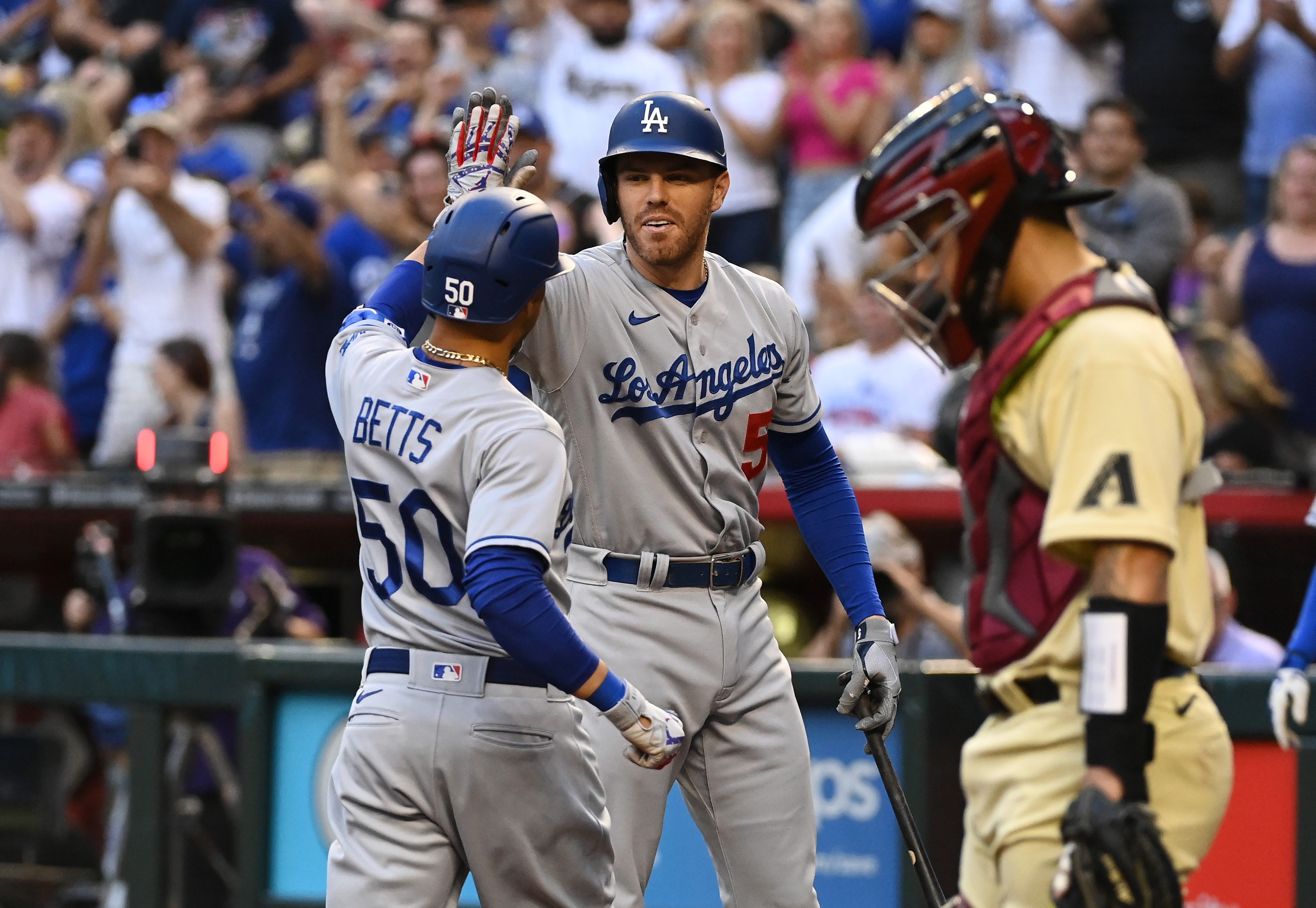 PHOENIX, ARIZONA - MAY 27: Mookie Betts #50 of the Los Angeles Dodgers celebrates with Freddie Freeman #5 after hitting a solo home run against the Arizona Diamondbacks during the second inning at Chase Field on May 27, 2022 in Phoenix, Arizona. (Photo by Norm Hall/Getty Images)