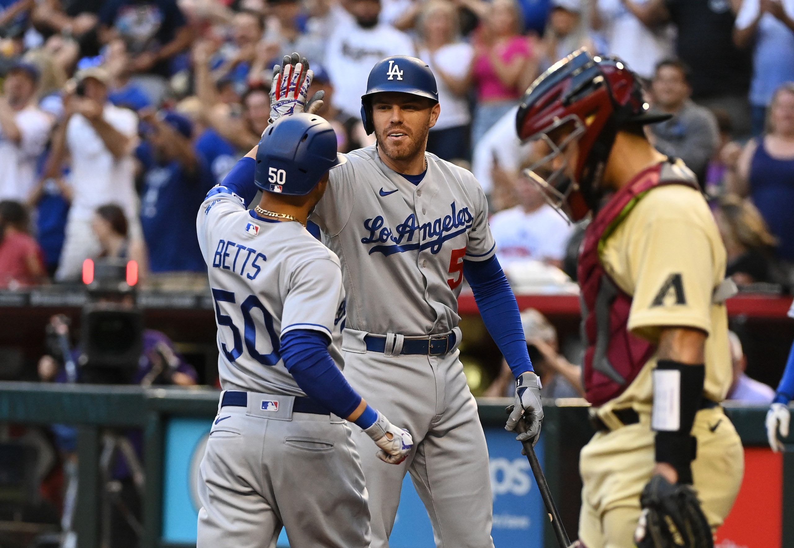 PHOENIX, ARIZONA - MAY 27: Mookie Betts #50 of the Los Angeles Dodgers celebrates with Freddie Freeman #5 after hitting a solo home run against the Arizona Diamondbacks during the second inning at Chase Field on May 27, 2022 in Phoenix, Arizona. (Photo by Norm Hall/Getty Images)
