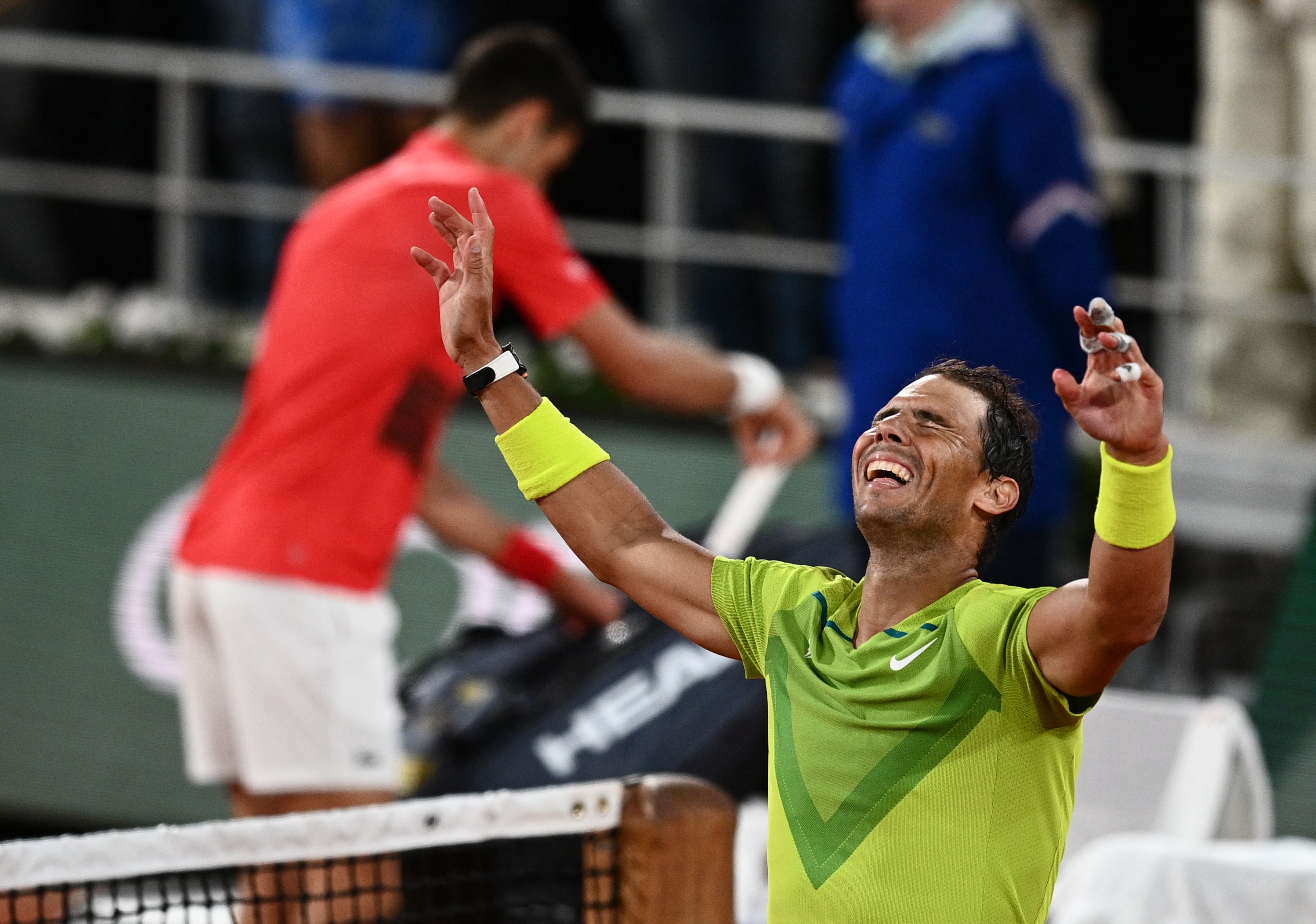 Spain's Rafael Nadal (R) reacts after winning against Serbia's Novak Djokovic (L) at the end of their men's singles match on day ten of the Roland-Garros Open tennis tournament at the Court Philippe-Chatrier in Paris early June 1, 2022. (Photo by Christophe ARCHAMBAULT / AFP) (Photo by CHRISTOPHE ARCHAMBAULT/AFP via Getty Images)