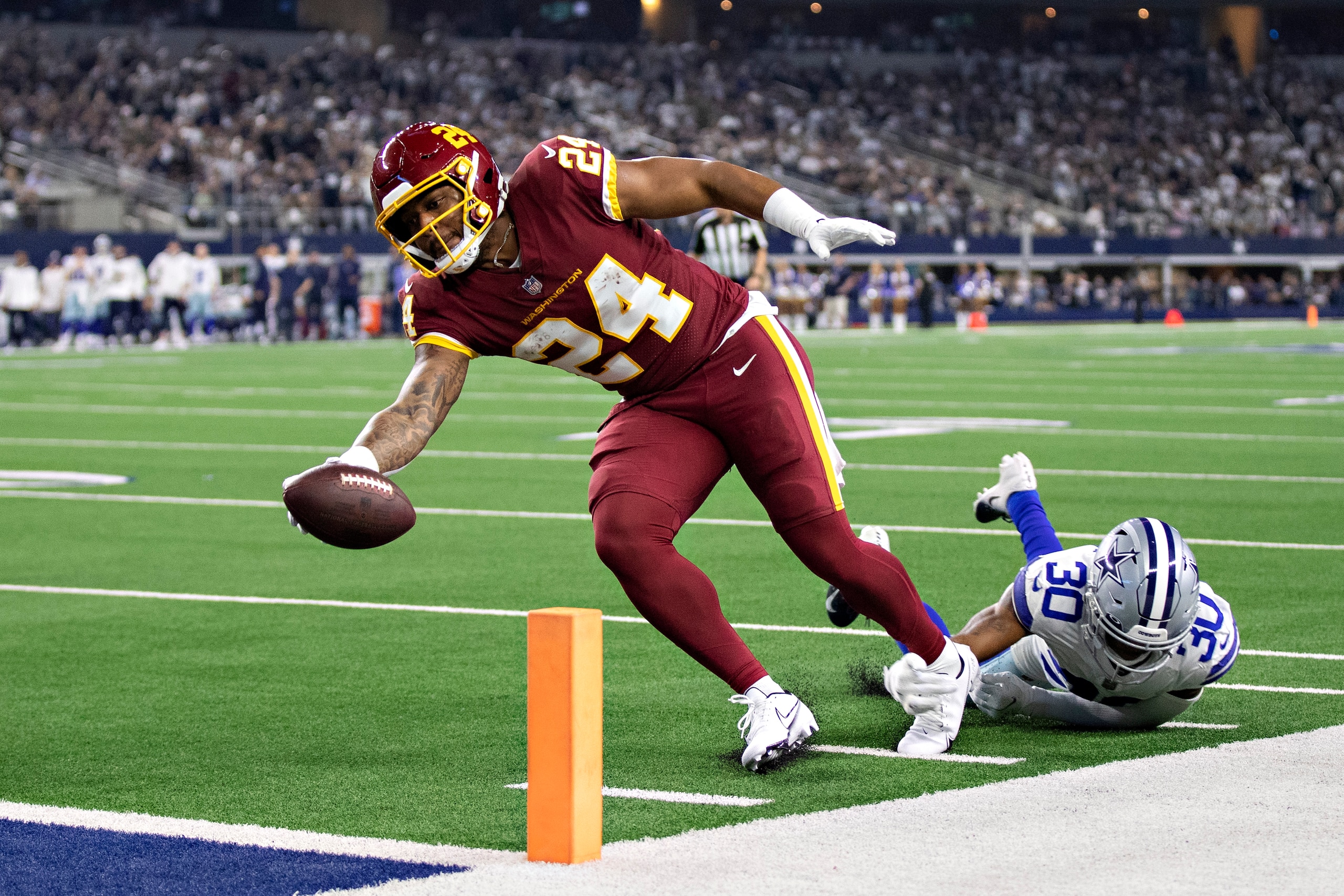 ARLINGTON, TEXAS - DECEMBER 26:  Antonio Gibson #24 of the Washington Football Team runs the ball for a touchdown during a game against the Dallas Cowboys at AT&T Stadium on December 26, 2021 in Arlington, Texas.  The Cowboys defeated the Football Team 56-14.  (Photo by Wesley Hitt/Getty Images)