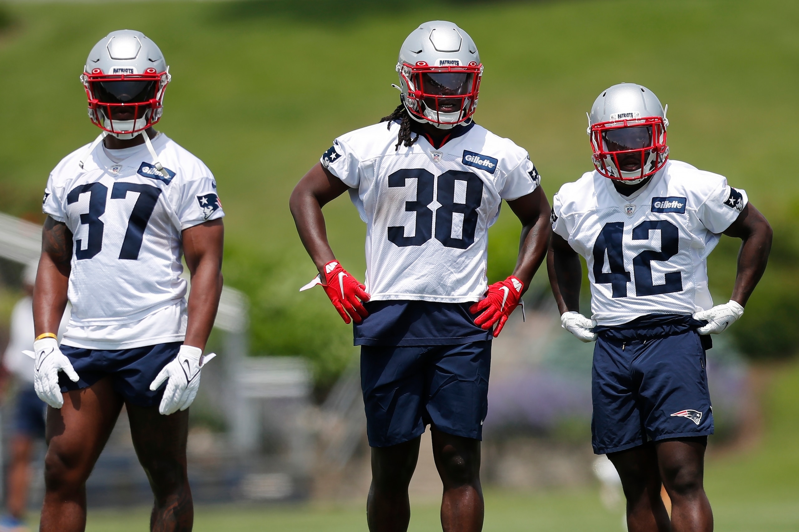 New England Patriots running backs Damien Harris (37), Rhamondre Stevenson (38) and J.J. Taylor (42) take part in drills at the NFL football team's practice facility in Foxborough, Mass., Tuesday, May 31, 2022 (AP Photo/Michael Dwyer)