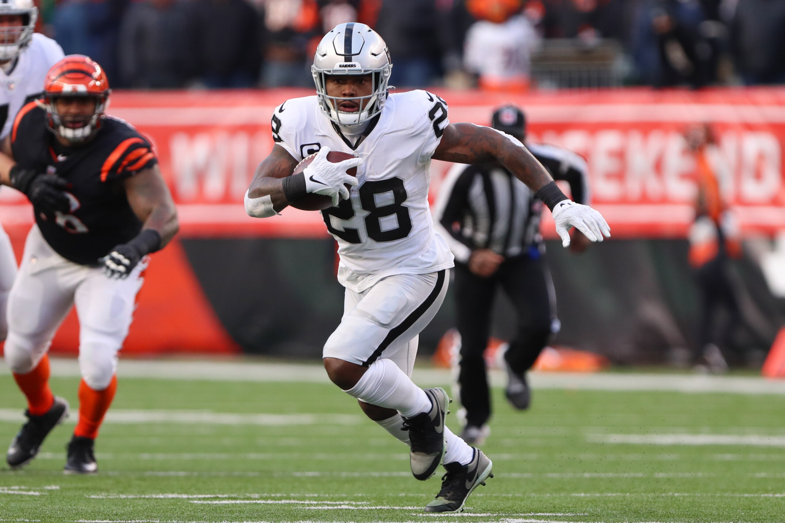 CINCINNATI, OH - JANUARY 15: Las Vegas Raiders running back Josh Jacobs (28) carries the ball during the Wild Card game against the Las Vegas Raiders and the Cincinnati Bengals on January 15, 2022, at Paul Brown Stadium in Cincinnati, OH. (Photo by Ian Johnson/Icon Sportswire via Getty Images)