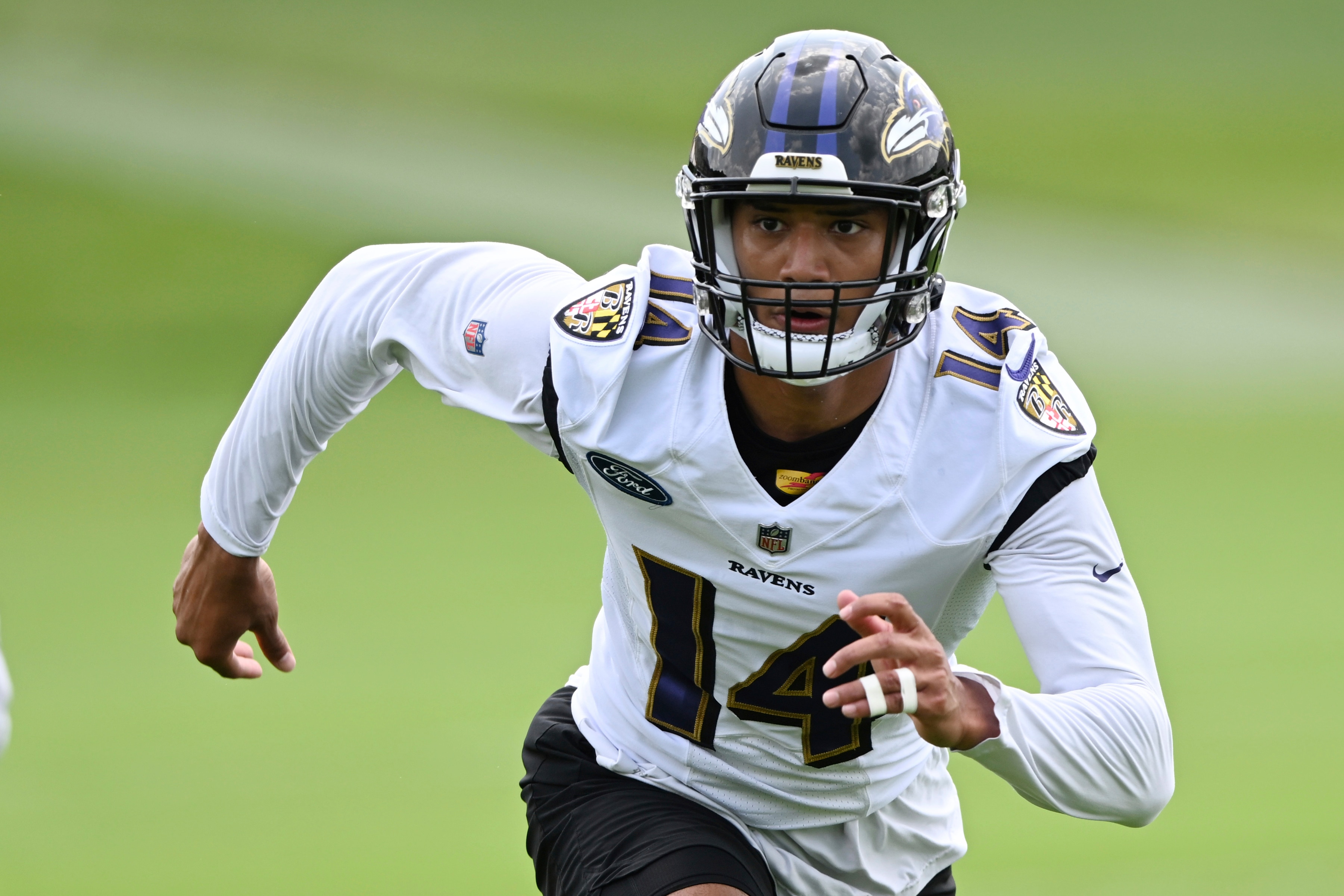 Baltimore Ravens safety Kyle Hamilton, right, runs a drill during a NFL football practice Wednesday, June 1, 2022, in Owings Mills, Md. (AP Photo/Gail Burton)