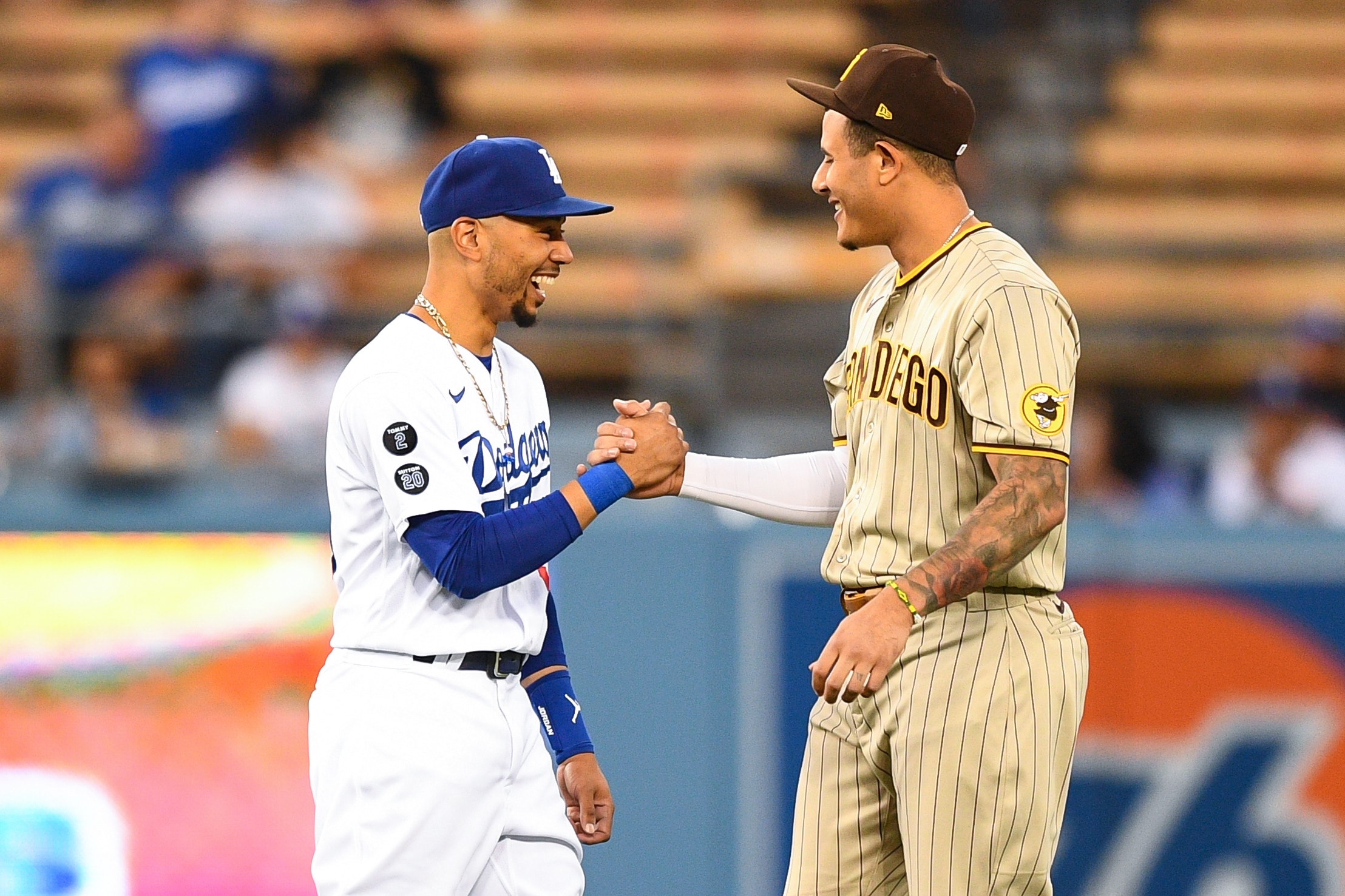 LOS ANGELES, CA - SEPTEMBER 10: Los Angeles Dodgers right fielder Mookie Betts (50) shares a moment with San Diego Padres third baseman Manny Machado (13) before the MLB game between the San Diego Padres and the Los Angeles Dodgers on September 10, 2021 at Dodger Stadium in Los Angeles, CA. (Photo by Brian Rothmuller/Icon Sportswire via Getty Images)