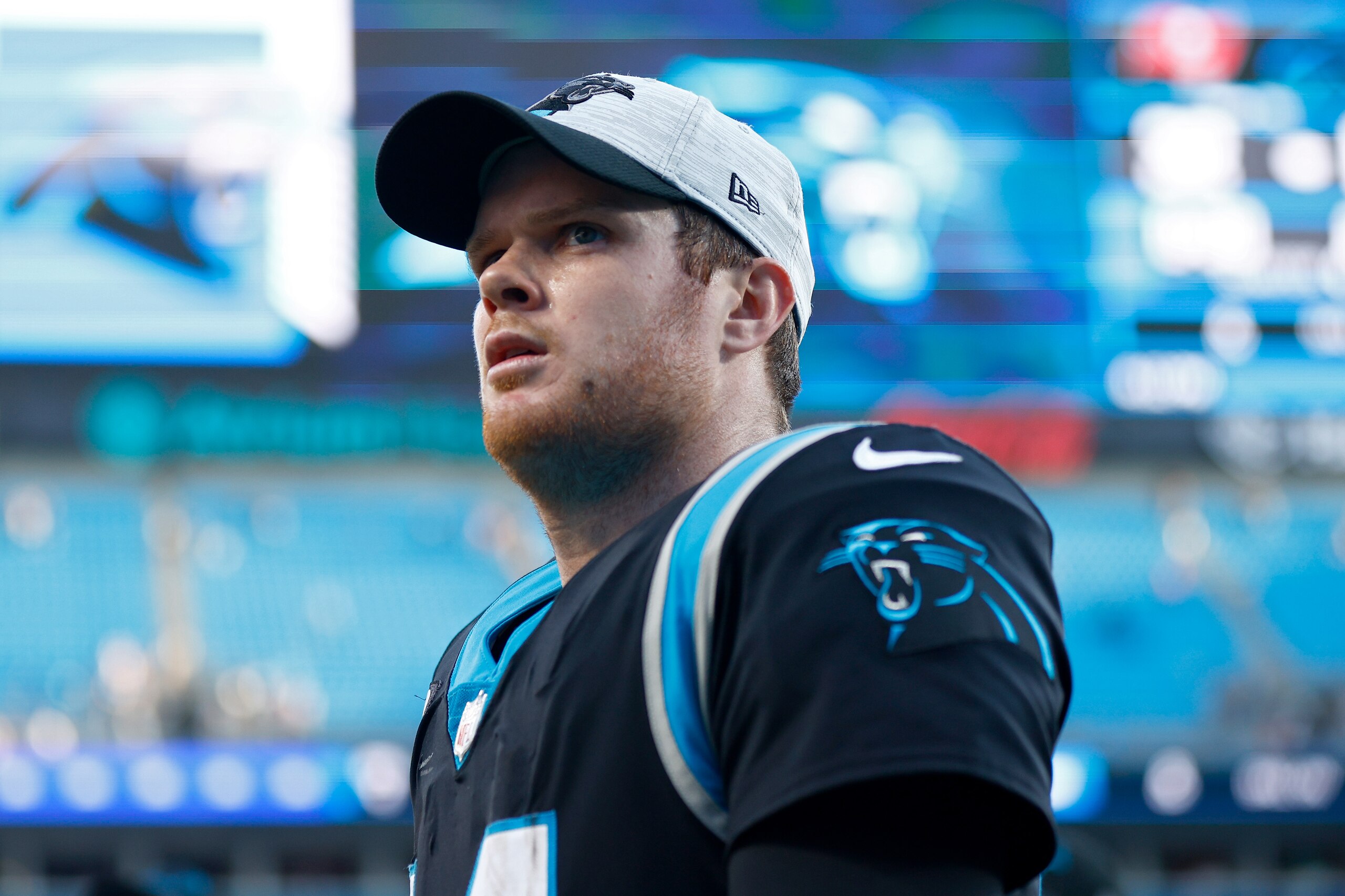 CHARLOTTE, NORTH CAROLINA - DECEMBER 26: Sam Darnold #14 of the Carolina Panthers walks off the field after a loss to the Tampa Bay Buccaneers at Bank of America Stadium on December 26, 2021 in Charlotte, North Carolina. (Photo by Jared C. Tilton/Getty Images) CHARLOTTE, NORTH CAROLINA - DECEMBER 26: Sam Darnold #14 of the Carolina Panthers walks off the field after a loss to the Tampa Bay Buccaneers at Bank of America Stadium on December 26, 2021 in Charlotte, North Carolina. (Photo by Jared C. Tilton/Getty Images)