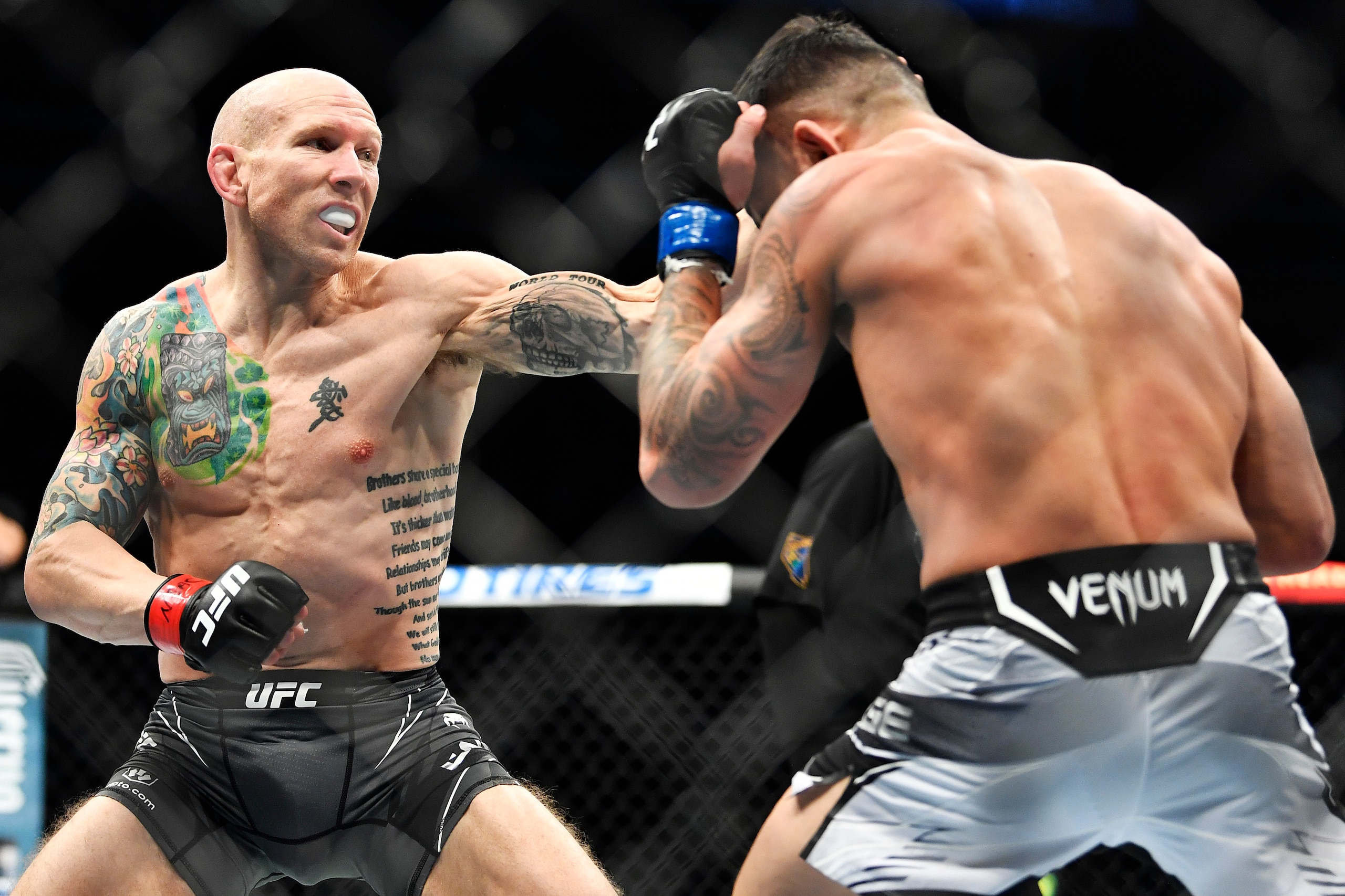 LAS VEGAS, NEVADA - DECEMBER 11: (L-R) Josh Emmett punches Dan Ige in their featherweight bout during the UFC 269 on December 11, 2021 in Las Vegas, Nevada. (Photo by Chris Unger/Zuffa LLC)