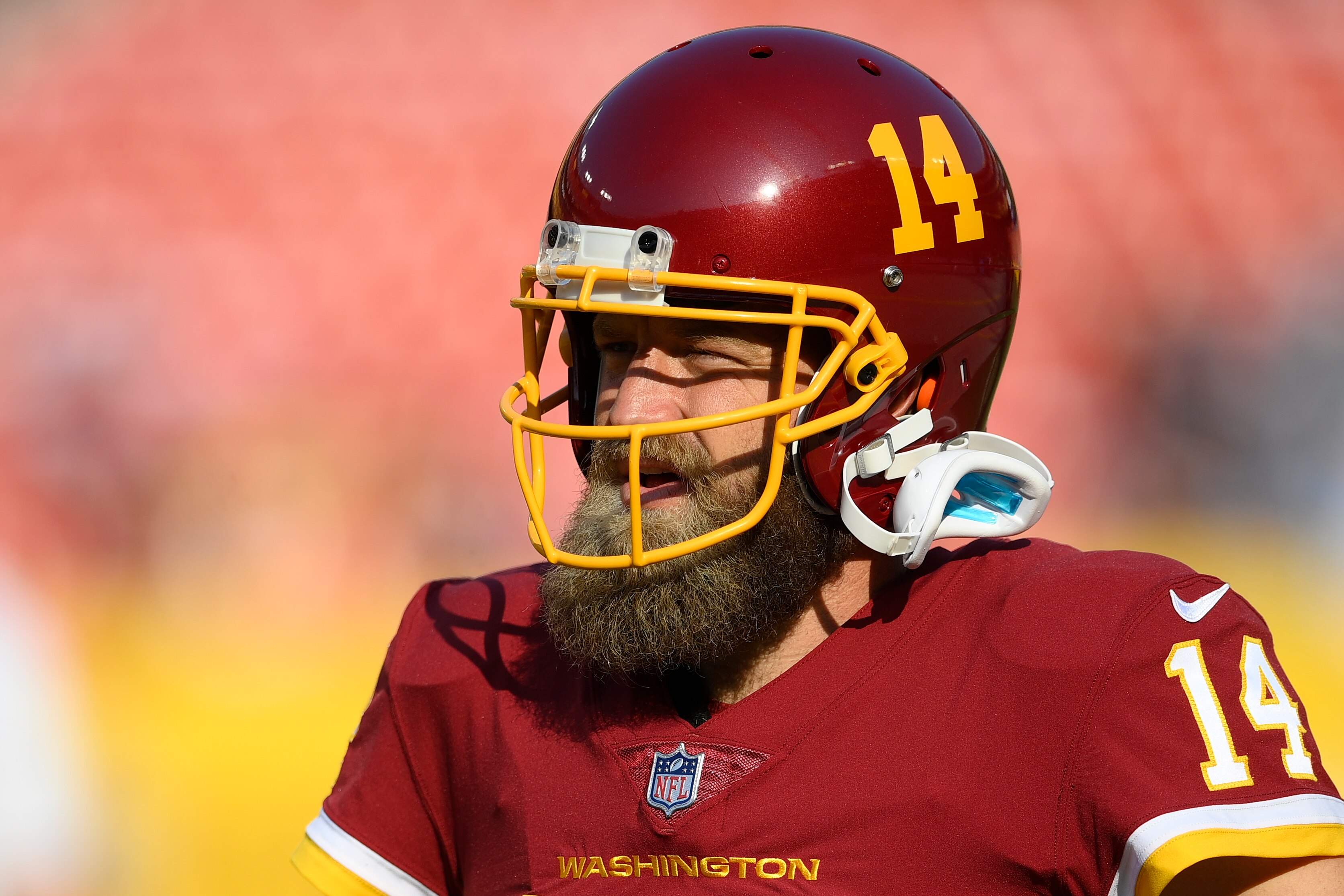 Washington Football Team quarterback Ryan Fitzpatrick (14) warms up prior to the start of a preseason NFL football game against the Baltimore Ravens, Saturday, Aug. 28, 2021, in Landover, Md. (AP Photo/Nick Wass)