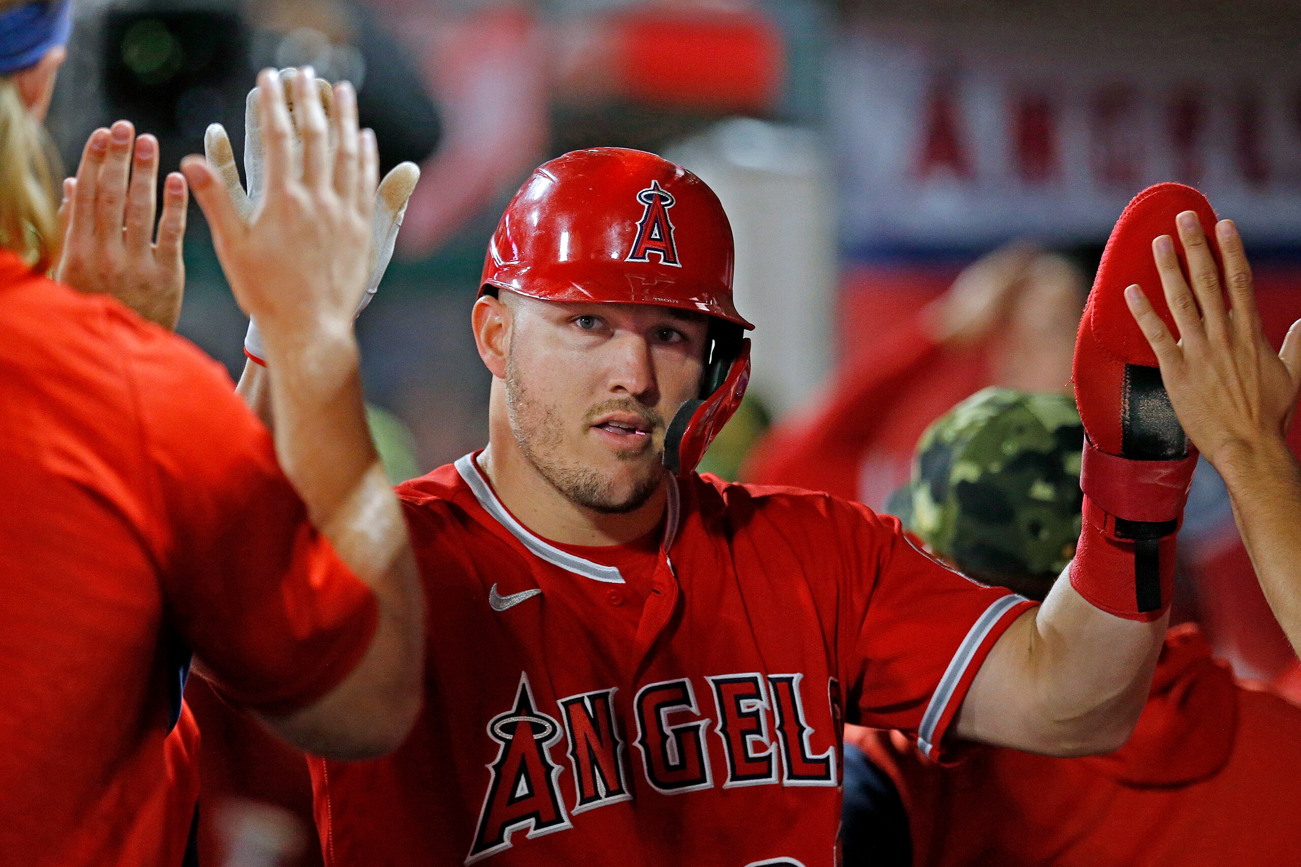 ANAHEIM, CA - MAY 21: Los Angeles Angels center fielder Mike Trout (27) is congrtulated by teammates after scoring on an infield single by Los Angeles Angels center fielder Brandon Marsh (16) in the bottom of the sixth inning in a game against the Oakland Athletics at Angel Stadium of Anaheim on Saturday, May 21, 2022 in Anaheim, CA. (Gary Coronado / Los Angeles Times via Getty Images)