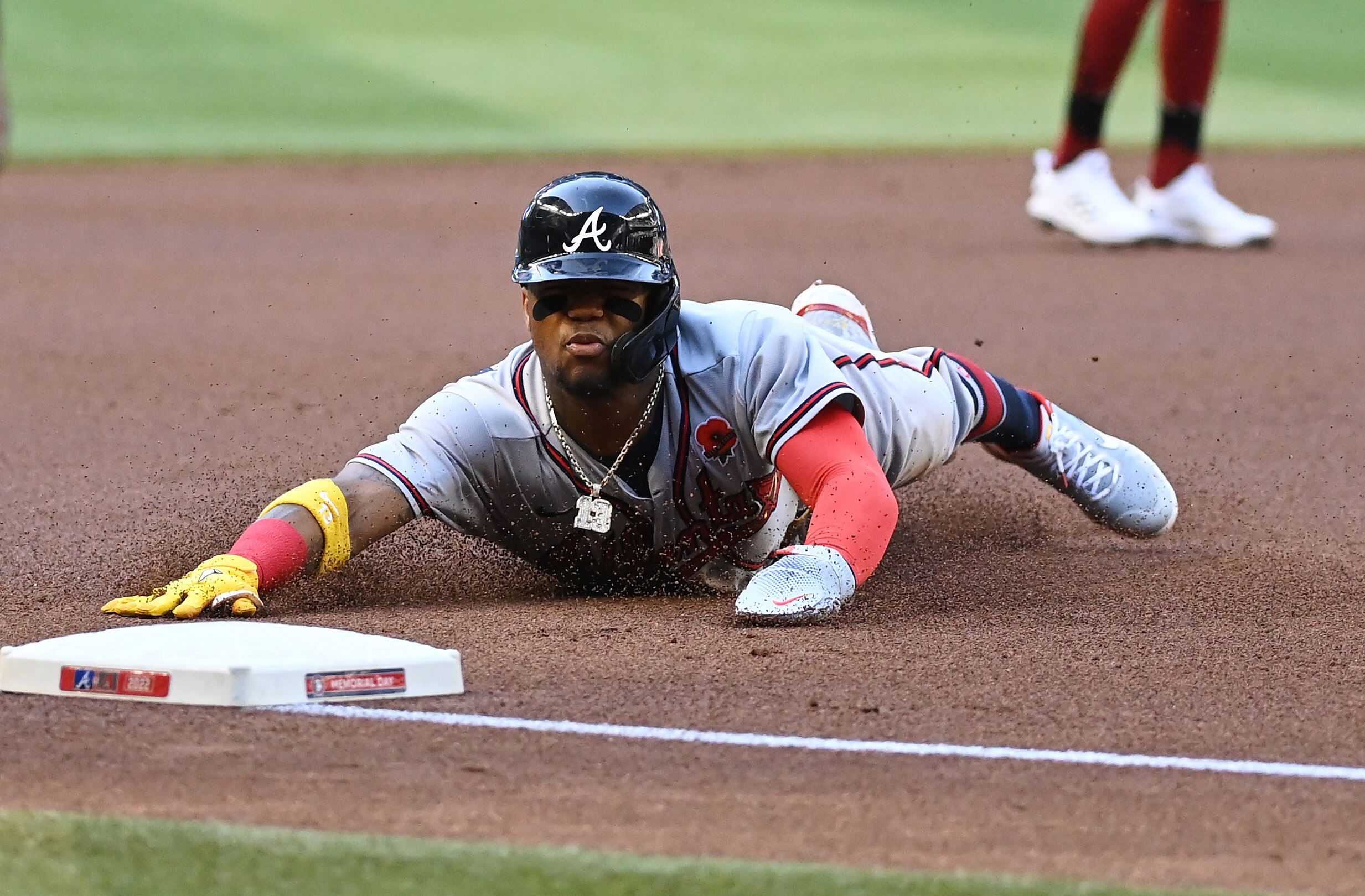 PHOENIX, ARIZONA - MAY 30: Ronald Acuna Jr #13 of the Atlanta Braves safely advances to third base on a single by Dansby Swanson #7 against the Arizona Diamondbacks during the first inning at Chase Field on May 30, 2022 in Phoenix, Arizona. (Photo by Norm Hall/Getty Images)