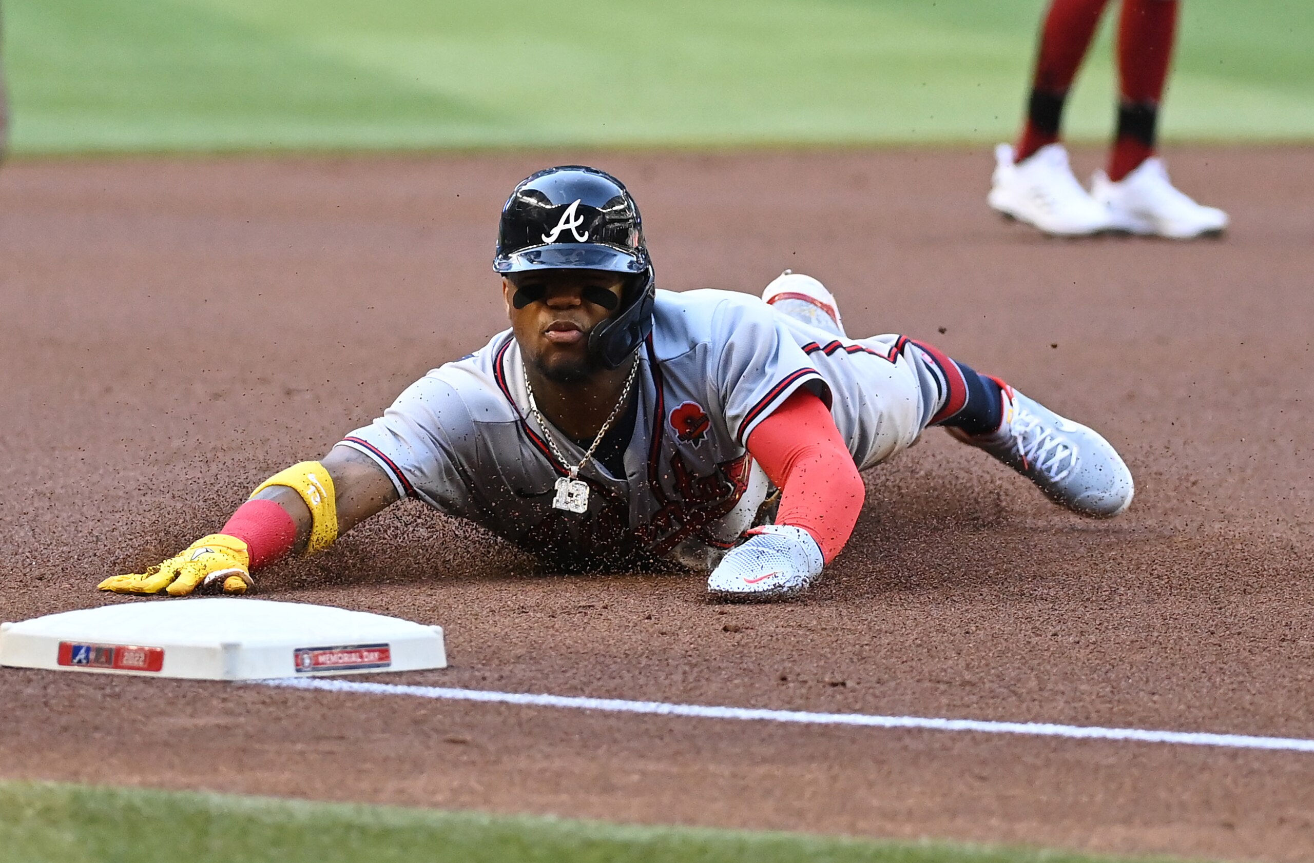 PHOENIX, ARIZONA - MAY 30: Ronald Acuna Jr #13 of the Atlanta Braves safely advances to third base on a single by Dansby Swanson #7 against the Arizona Diamondbacks during the first inning at Chase Field on May 30, 2022 in Phoenix, Arizona. (Photo by Norm Hall/Getty Images)
