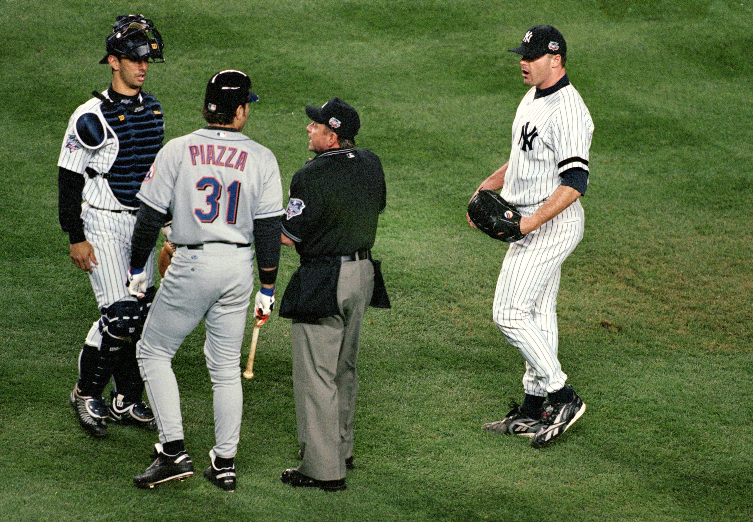 22 Oct 2000: #31 Mike Piazza of the New York Mets is restrained from pitcher #22 Roger Clemens of the New York Yankees by home plate umpire Charlie Reliford in the first inning during Game 2 of the MLB World Series at Yankee Stadium in the Bronx, New York. Mandatory Credit: Al Bello/ALLSPORT 22 Oct 2000: #31 Mike Piazza of the New York Mets is restrained from pitcher #22 Roger Clemens of the New York Yankees by home plate umpire Charlie Reliford in the first inning during Game 2 of the MLB World Series at Yankee Stadium in the Bronx, New York. Mandatory Credit: Al Bello/ALLSPORT