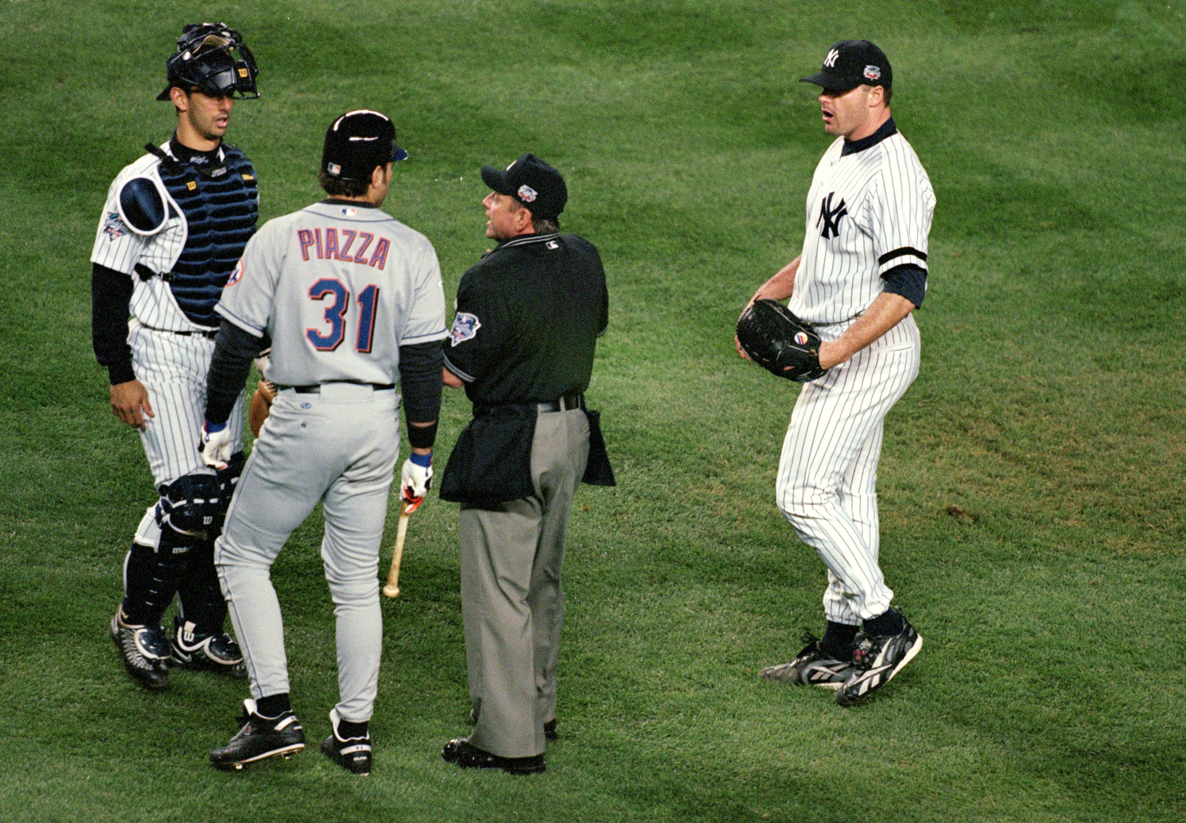 22 Oct 2000:  #31 Mike Piazza of the New York Mets is restrained from pitcher #22 Roger Clemens of the New York Yankees by home plate umpire Charlie Reliford in the first inning during Game 2 of the MLB World Series at Yankee Stadium in the Bronx, New York. Mandatory Credit: Al Bello/ALLSPORT