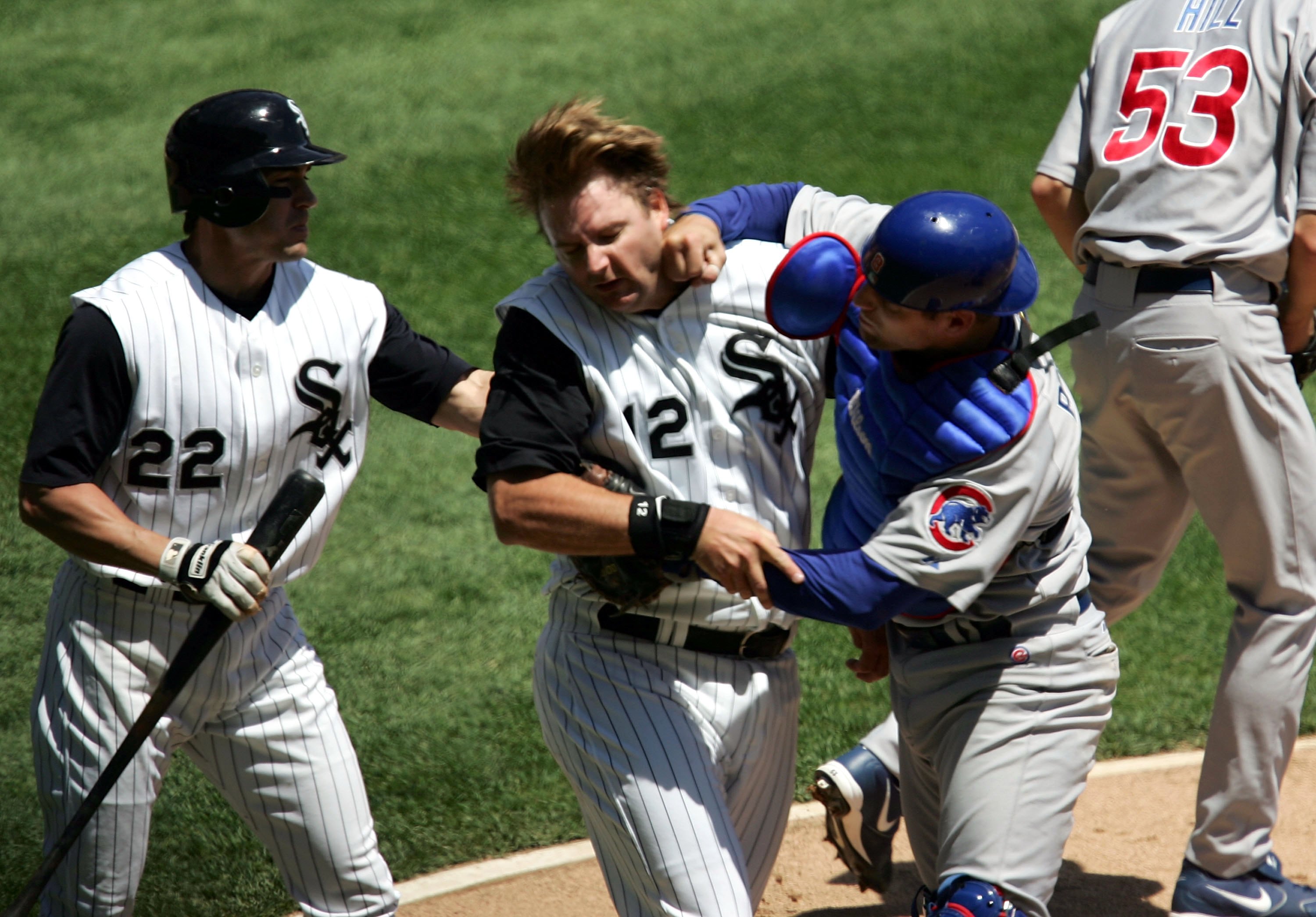CHICAGO - MAY 20:  Michael Barrett #8 of the Chicago Cubs punches A.J. Pierzynski #12 of the Chicago White Sox after a second inning collision as Scott Podsednik #22 steps in on May 20, 2006 at U.S. Cellular Field in Chicago, Illinois.  (Photo by Jonathan Daniel/Getty Images)