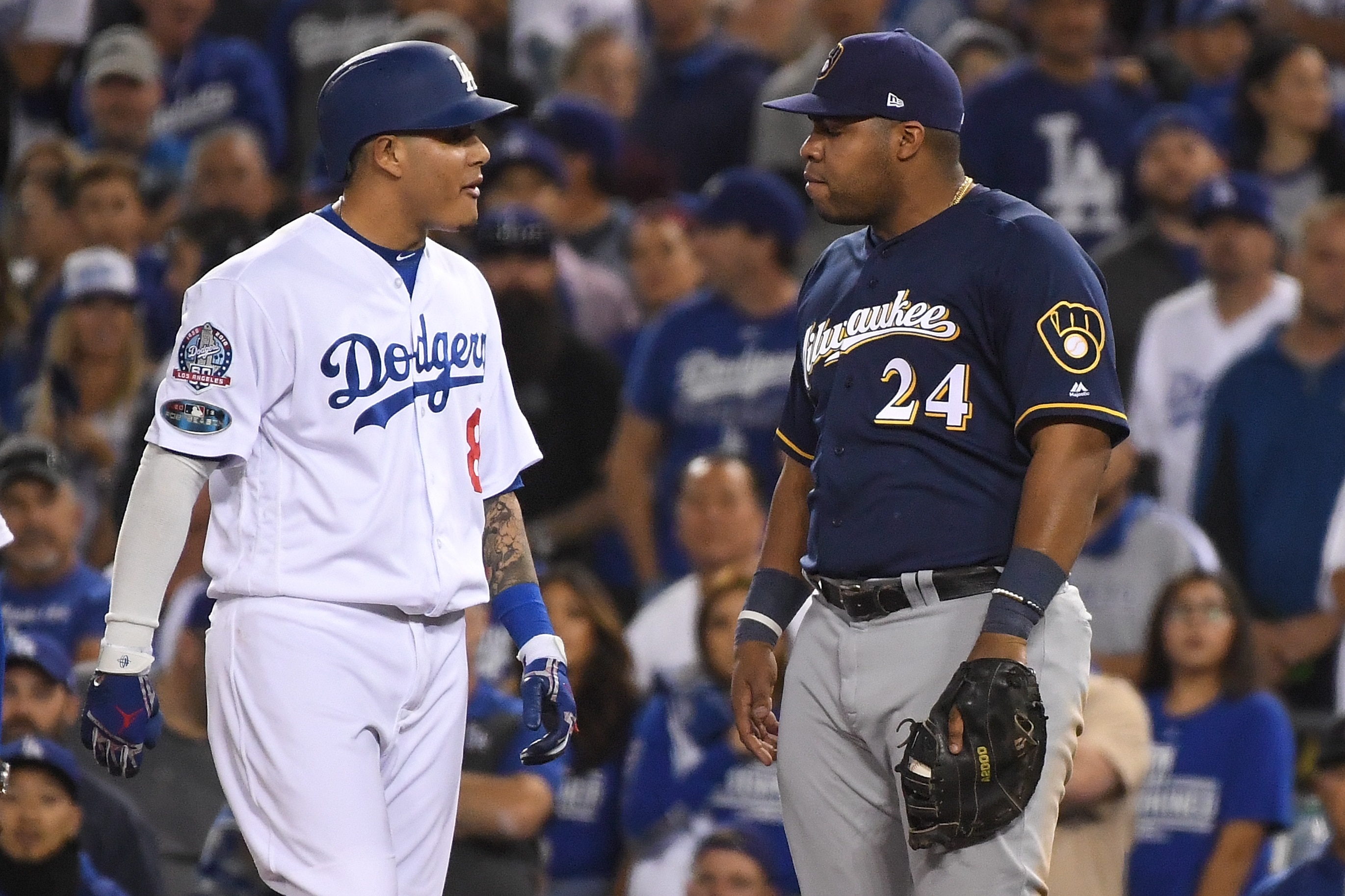 LOS ANGELES, CA - OCTOBER 16:  Manny Machado #8 of the Los Angeles Dodgers and Jesus Aguilar #24 of the Milwaukee Brewers exchange words during the tenth inning in Game Four of the National League Championship Series at Dodger Stadium on October 16, 2018 in Los Angeles, California.  (Photo by Harry How/Getty Images)