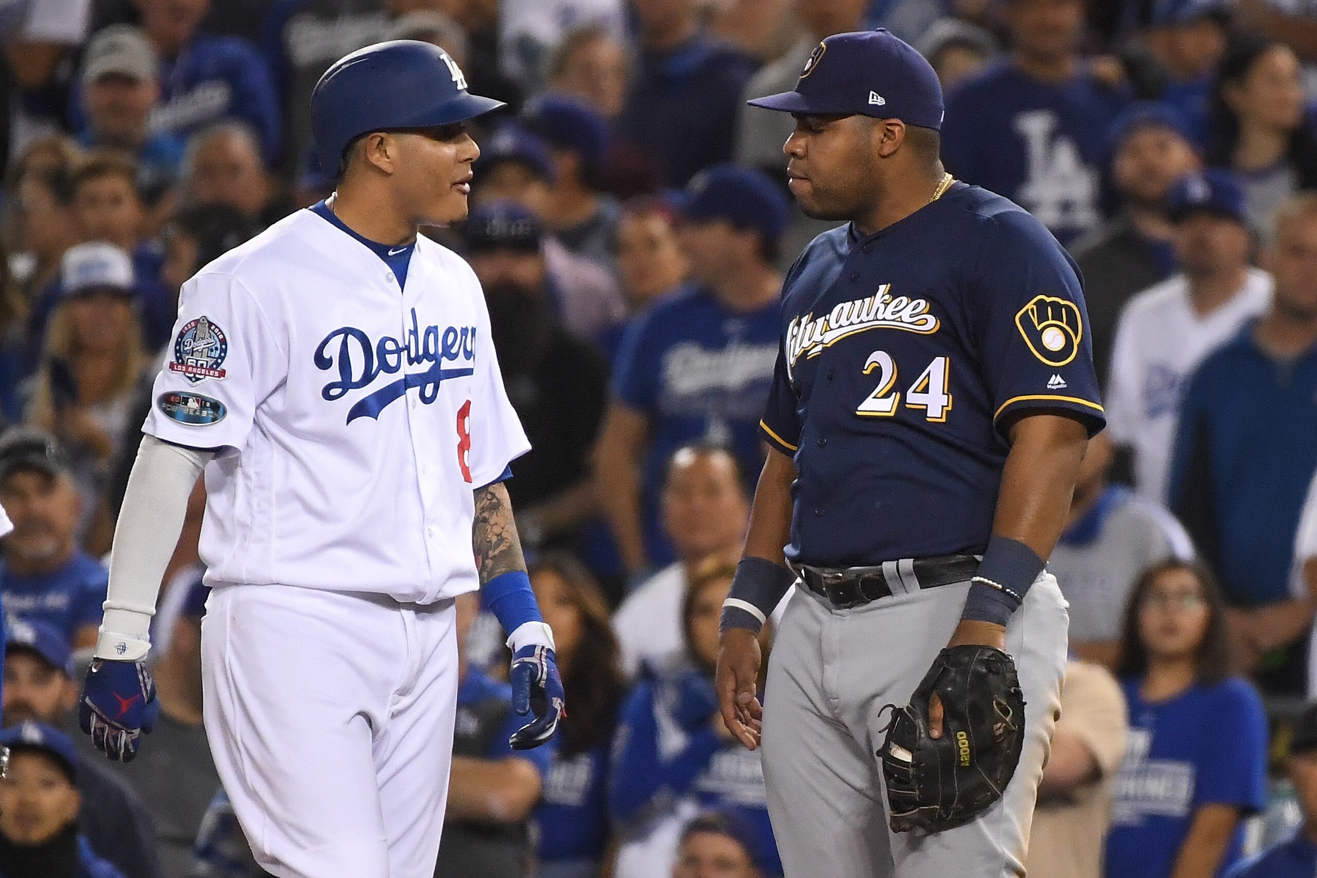 LOS ANGELES, CA - OCTOBER 16: Manny Machado #8 of the Los Angeles Dodgers and Jesus Aguilar #24 of the Milwaukee Brewers exchange words during the tenth inning in Game Four of the National League Championship Series at Dodger Stadium on October 16, 2018 in Los Angeles, California. (Photo by Harry How/Getty Images) LOS ANGELES, CA - OCTOBER 16: Manny Machado #8 of the Los Angeles Dodgers and Jesus Aguilar #24 of the Milwaukee Brewers exchange words during the tenth inning in Game Four of the National League Championship Series at Dodger Stadium on October 16, 2018 in Los Angeles, California. (Photo by Harry How/Getty Images)