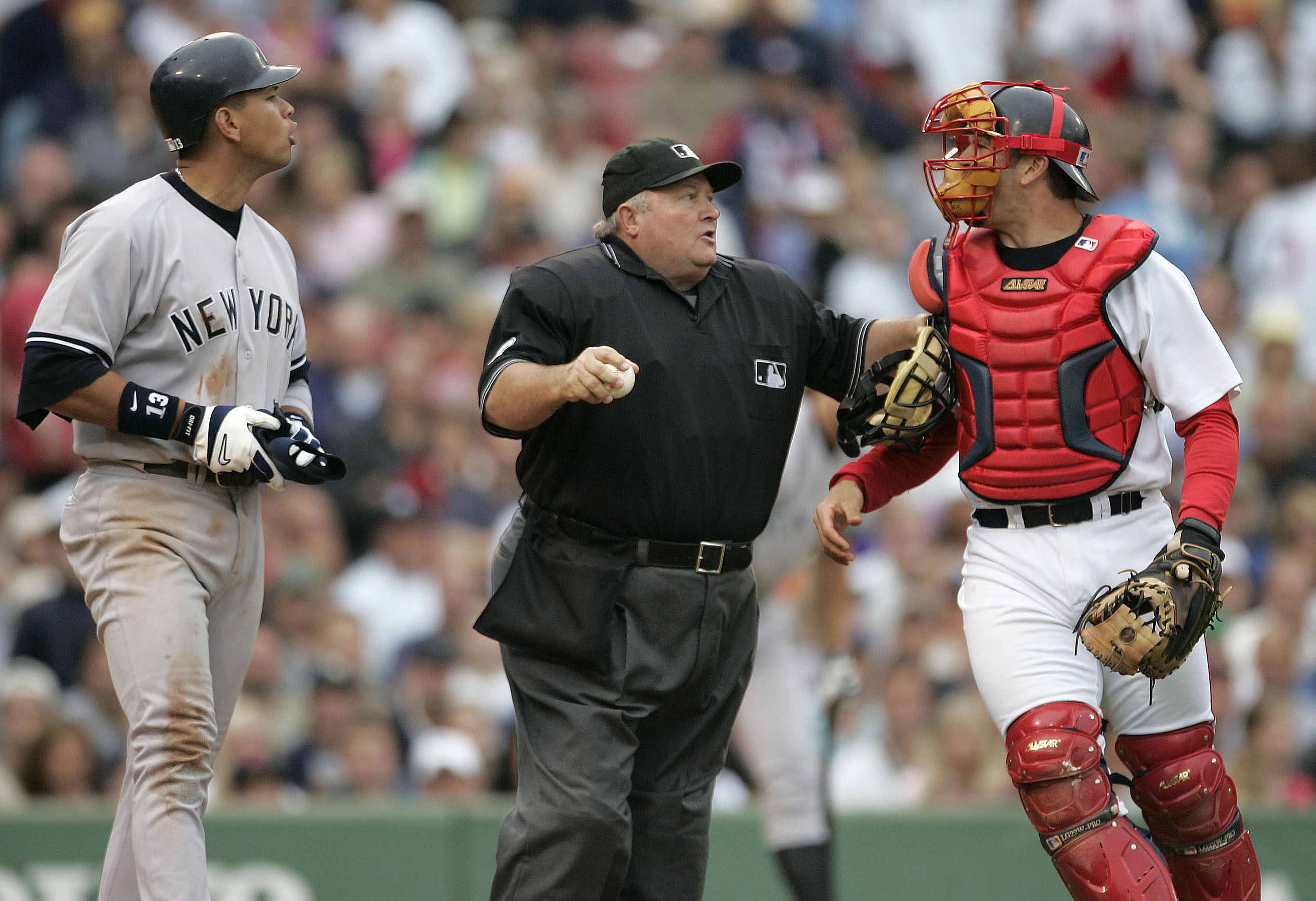Home plate umpire Bruce Froemming, attempts to keep Boston Red Sox catcher Jason Varitek, right, away New York Yankees batter Alex Rodriguez in the third inning after Rodriguez was hit by a pitch by Red Sox's Bronson Arroyo  at Fenway Park in Boston.  Varitek and Rodriguez were removed from the game after the two fought, an incident that ended in a bench-clearing brawl.  The Red Sox won, 11-10,  with a 9th-inning game winning home run by Bill Mueller (Photo by J Rogash/WireImage)