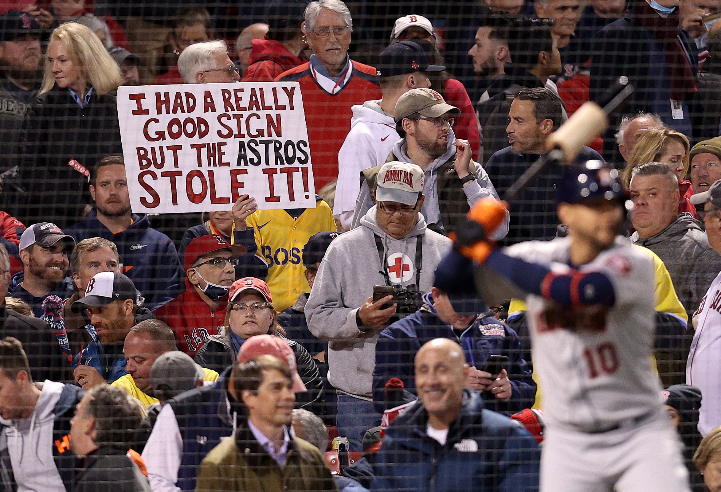 BOSTON, MASSACHUSETTS - OCTOBER 18: A sign referring to the Houston Astros cheating is held by a fan during the Boston Red Sox game against the Houston Astros in Game Three of the American League Championship Series at Fenway Park on October 18, 2021 in Boston, Massachusetts. (Photo by Maddie Meyer/Getty Images)