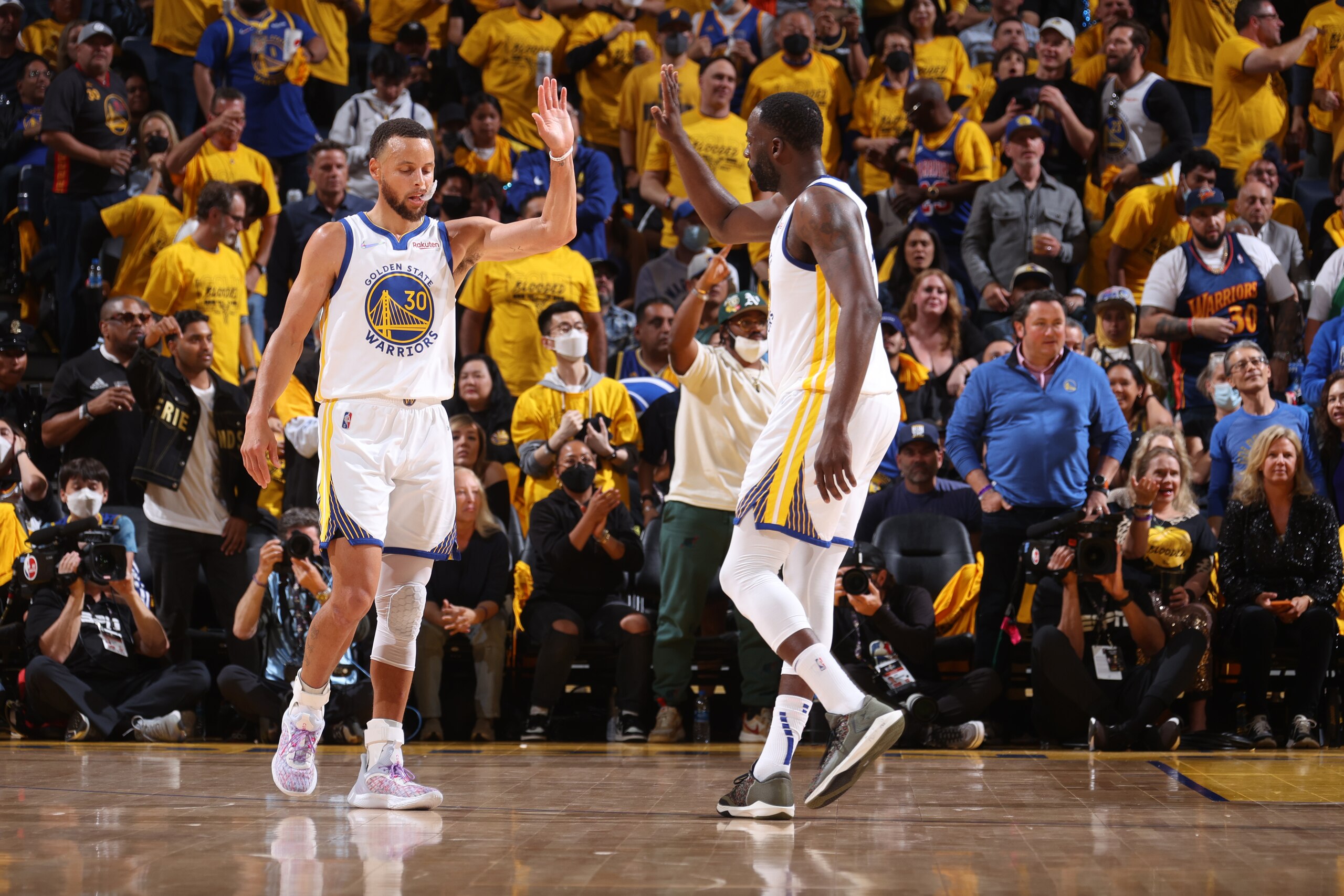 SAN FRANCISCO, CA - JUNE 2: Stephen Curry #30 and Draymond Green #23 of the Golden State Warriors high five during Game One of the 2022 NBA Finals against the Boston Celtics on June 2, 2022 at Chase Center in San Francisco, California. NOTE TO USER: User expressly acknowledges and agrees that, by downloading and or using this photograph, user is consenting to the terms and conditions of Getty Images License Agreement. Mandatory Copyright Notice: Copyright 2022 NBAE (Photo by Nathaniel S. Butler/NBAE via Getty Images)