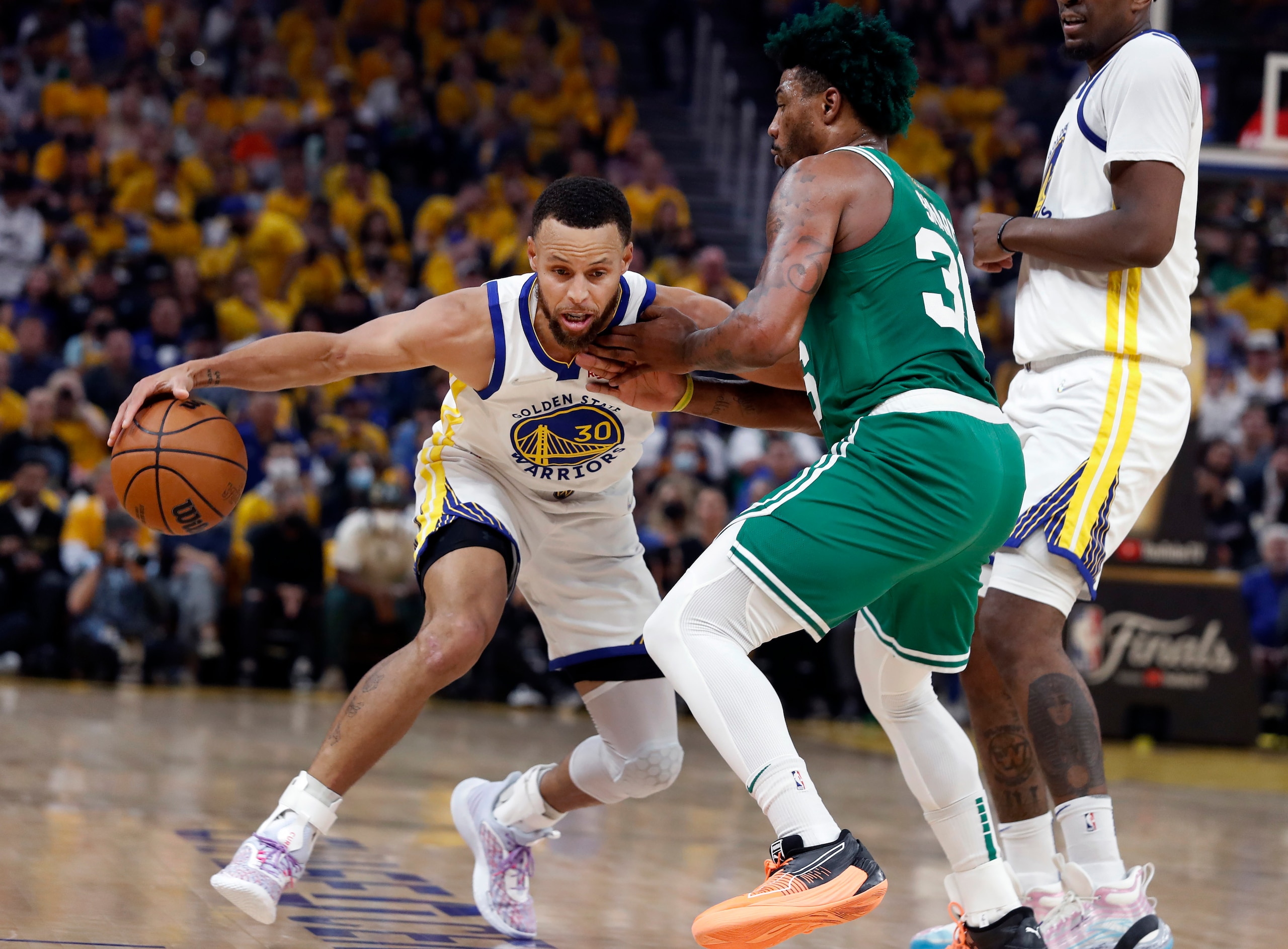 Boston - June 2: The Warriors Stephen Curry (30) is guarded by the Celtics Marcus Smart in the first quarter. The Boston Celtics visited the Golden State Warriors for Game One of the NBA Finals at the Chase Center in San Francisco, CA on June 2, 2022. (Photo by Jim Davis/The Boston Globe via Getty Images)