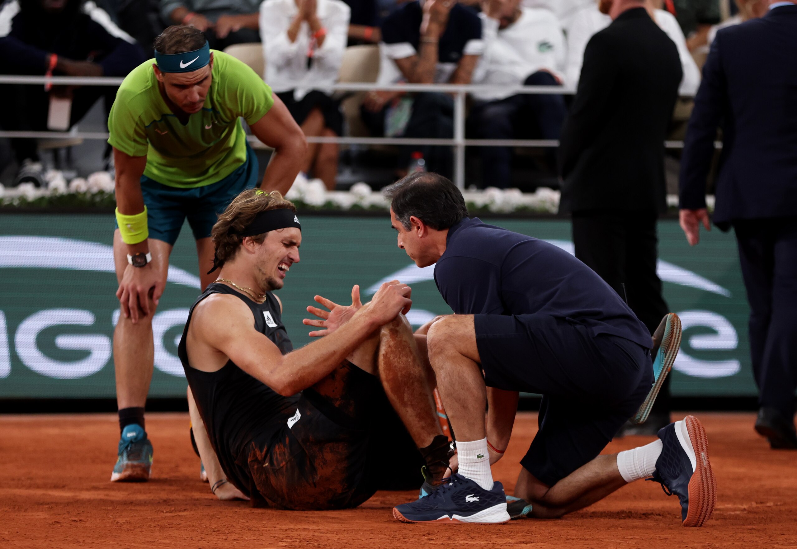 PARIS, FRANCE - JUNE 03: Rafael Nadal of Spain checks on Alexander Zverev of Germany as he receives medical attention following an injury against Rafael Nadal of Spain during the Men's Singles Semi Final match on Day 13 of The 2022 French Open at Roland Garros on June 03, 2022 in Paris, France (Photo by Clive Brunskill/Getty Images)