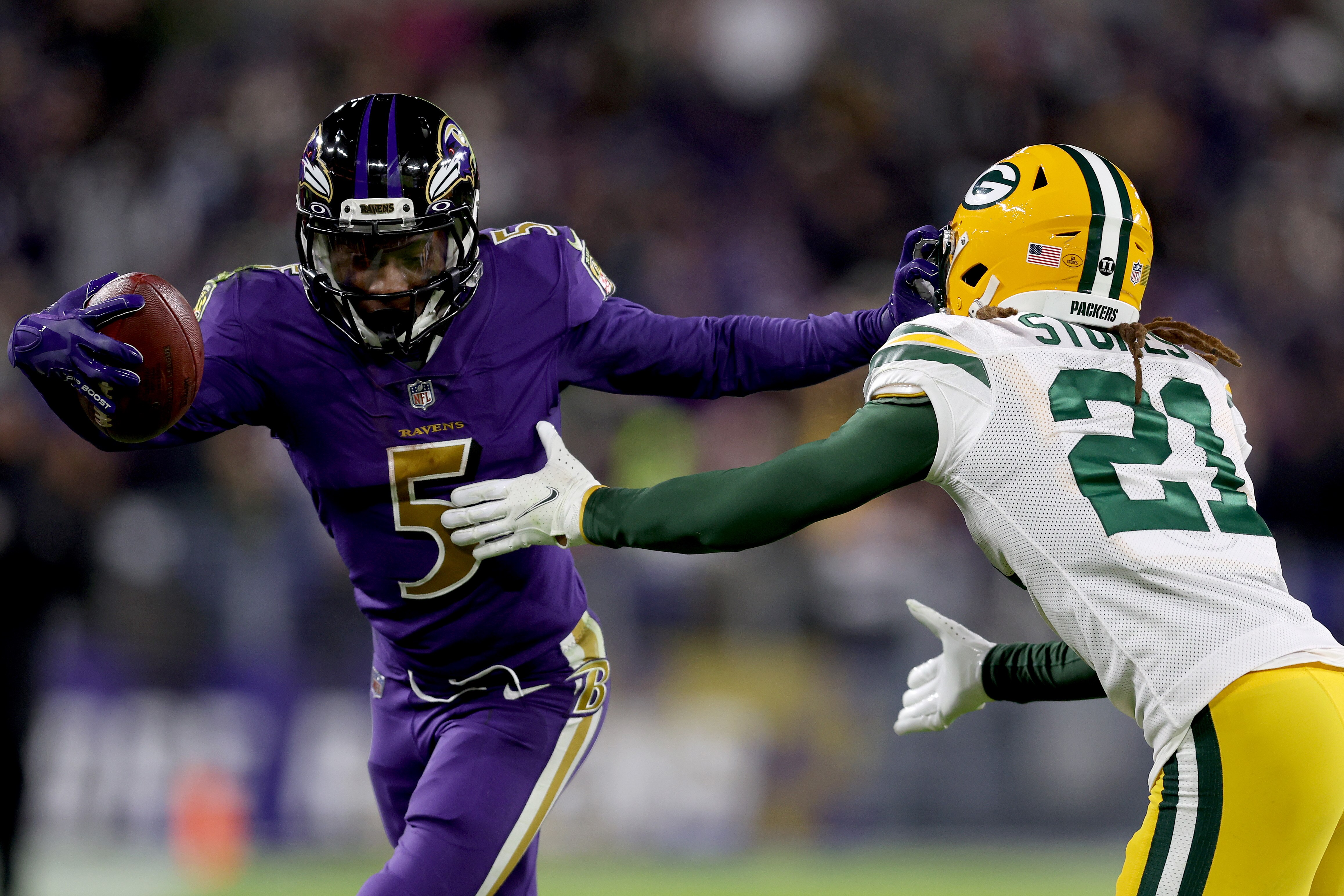BALTIMORE, MARYLAND - DECEMBER 19: Marquise Brown #5 of the Baltimore Ravens runs with the ball after the catch against Eric Stokes #21 of the Green Bay Packers in the fourth quarter at M&T Bank Stadium on December 19, 2021 in Baltimore, Maryland. (Photo by Patrick Smith/Getty Images)