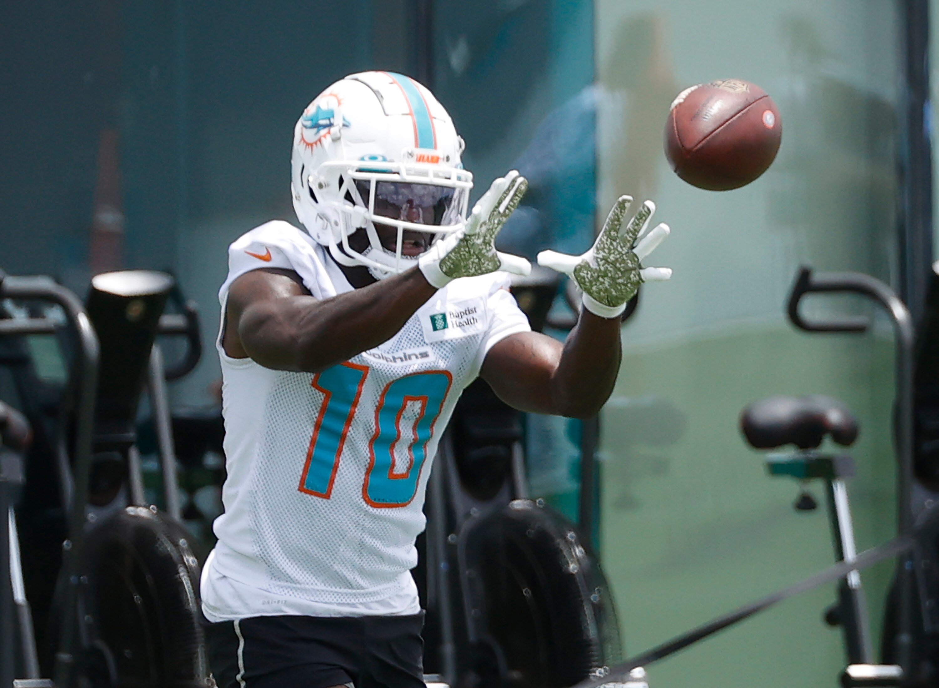 MIAMI GARDENS, FL - MAY 24: Tyreek Hill #10 of the Miami Dolphins catches the ball during the Miami Dolphins OTAs at the Baptist Health Training Complex on May 24, 2022 in Miami Gardens, Florida. (Photo by Joel Auerbach/Getty Images)