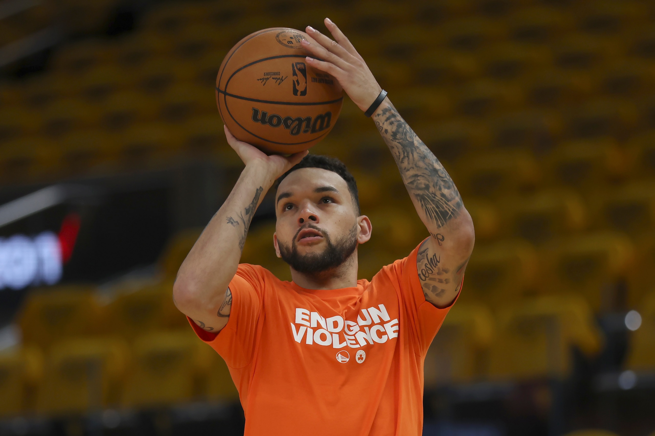 Golden State Warriors guard Chris Chiozza wears a shirt that reads End Gun Violence while warming up before Game 2 of basketball's NBA Finals against the Boston Celtics in San Francisco, Sunday, June 5, 2022. (AP Photo/Jed Jacobsohn)