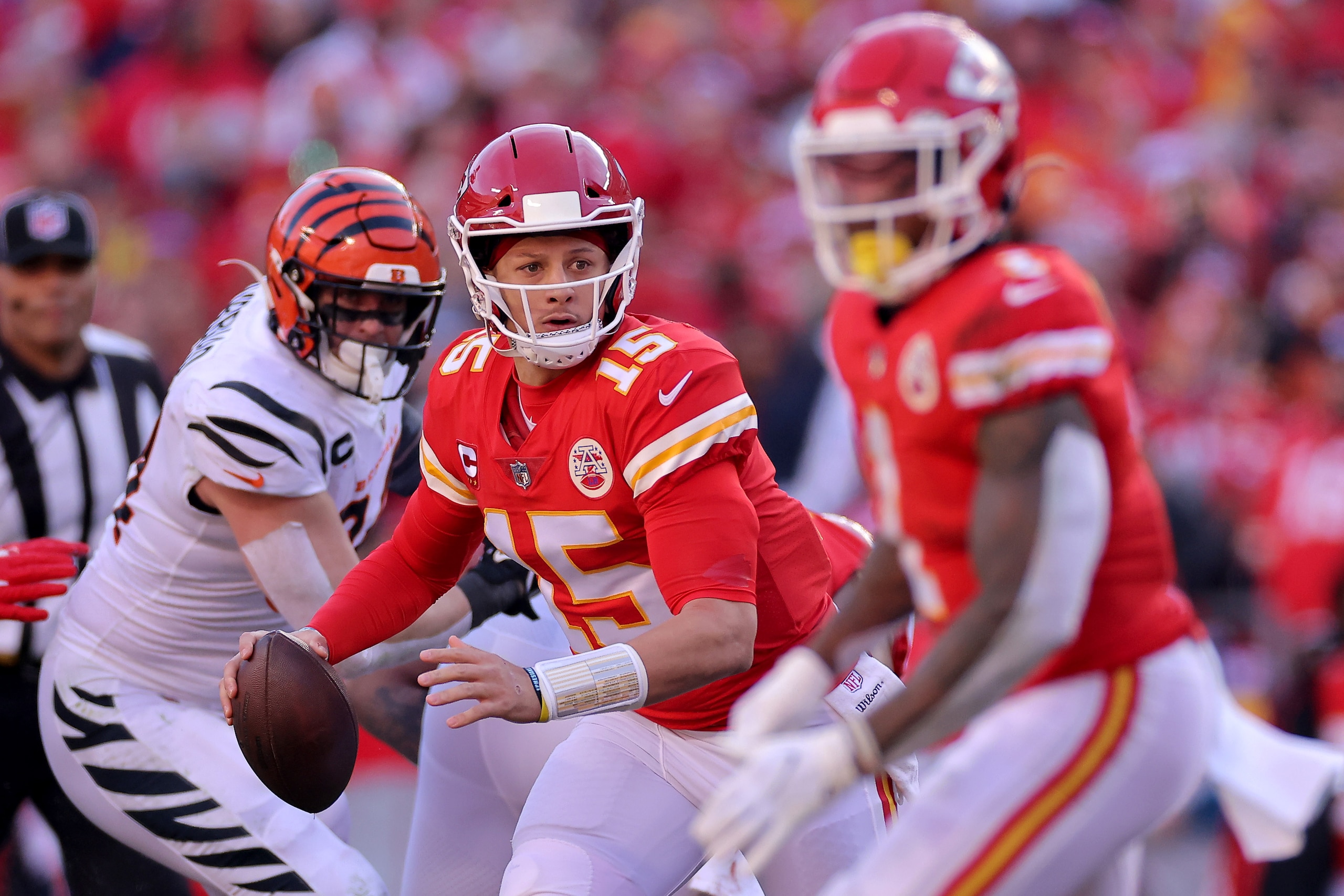 KANSAS CITY, MISSOURI - JANUARY 30: Quarterback Patrick Mahomes #15 of the Kansas City Chiefs looks to pass against the Cincinnati Bengals during the first half of the AFC Championship Game at Arrowhead Stadium on January 30, 2022 in Kansas City, Missouri. (Photo by David Eulitt/Getty Images)