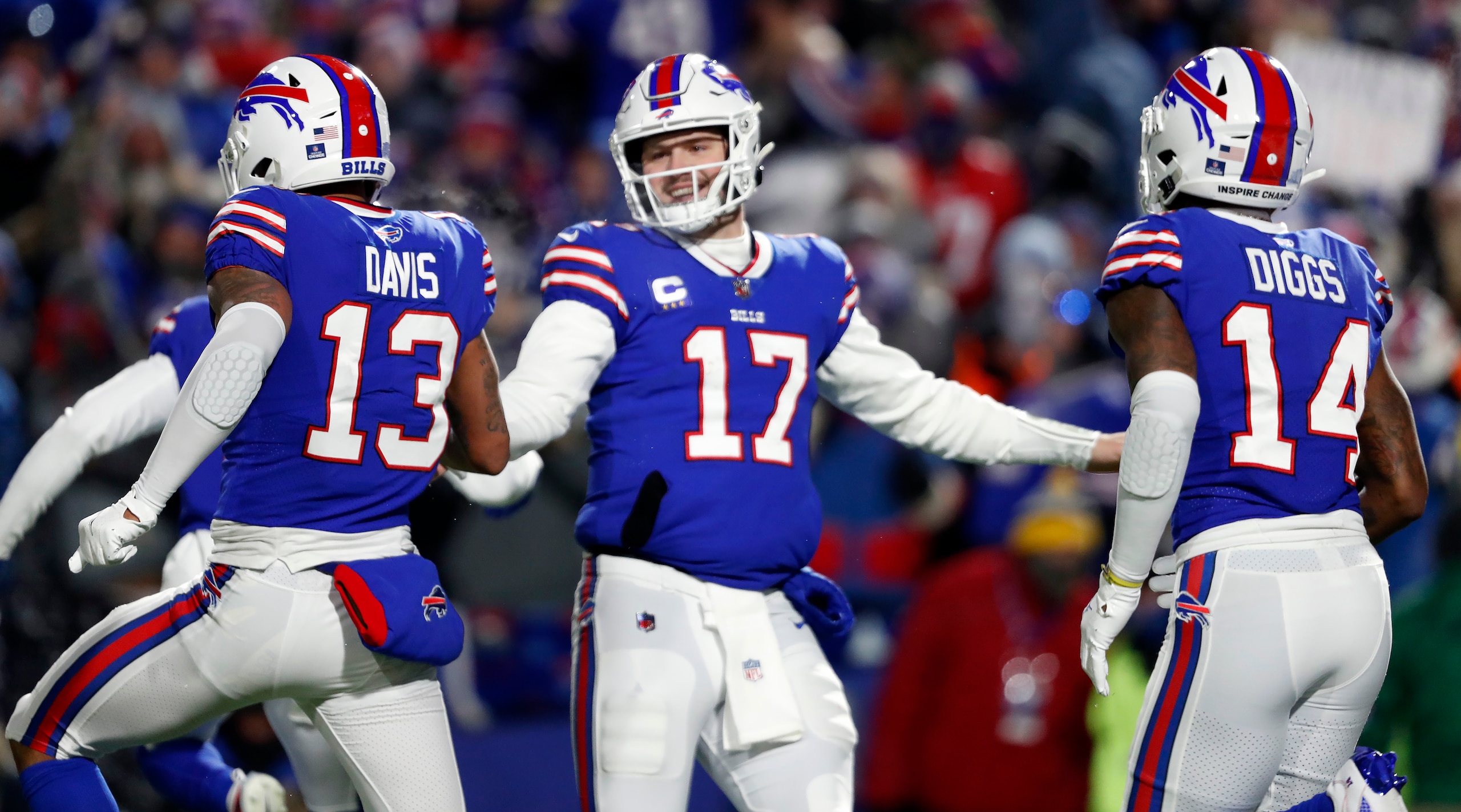Orchard Park, NY - January 15: Bills quarterback Josh Allen (17) celebrates with WRs Gabriel Davis (left) and Stefon Diggs (right) after a fourth quarter touchdown scored by Davis.  The Buffalo Bills host the New England Patriots in a AFC wild-card game Saturday night January 15, 2022 at Highmark Stadium in Orchard Park, NY. (Photo by Jim Davis/The Boston Globe via Getty Images)