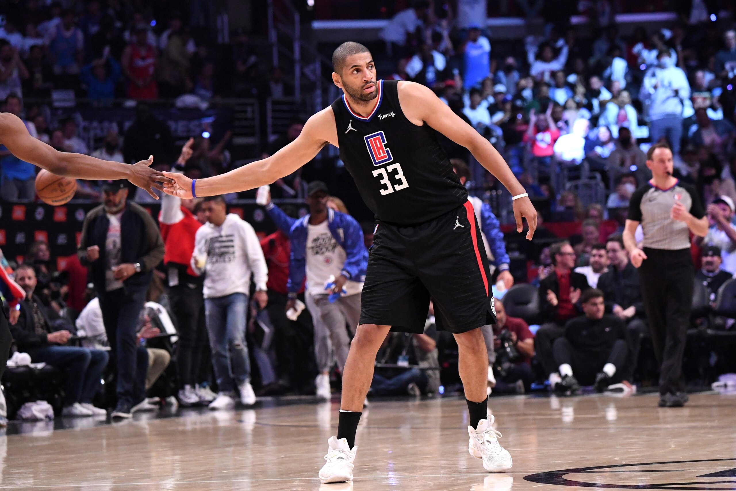 LOS ANGELES, CA - APRIL 15: Terance Mann #14 of the LA Clippers high fives Nicolas Batum #33 against the New Orleans Pelicans during the 2022 play-in tournament on April 15, 2022 at Crypto.Com Arena in Los Angeles, California. NOTE TO USER: User expressly acknowledges and agrees that, by downloading and/or using this Photograph, user is consenting to the terms and conditions of the Getty Images License Agreement. Mandatory Copyright Notice: Copyright 2022 NBAE (Photo by Adam Pantozzi/NBAE via Getty Images)